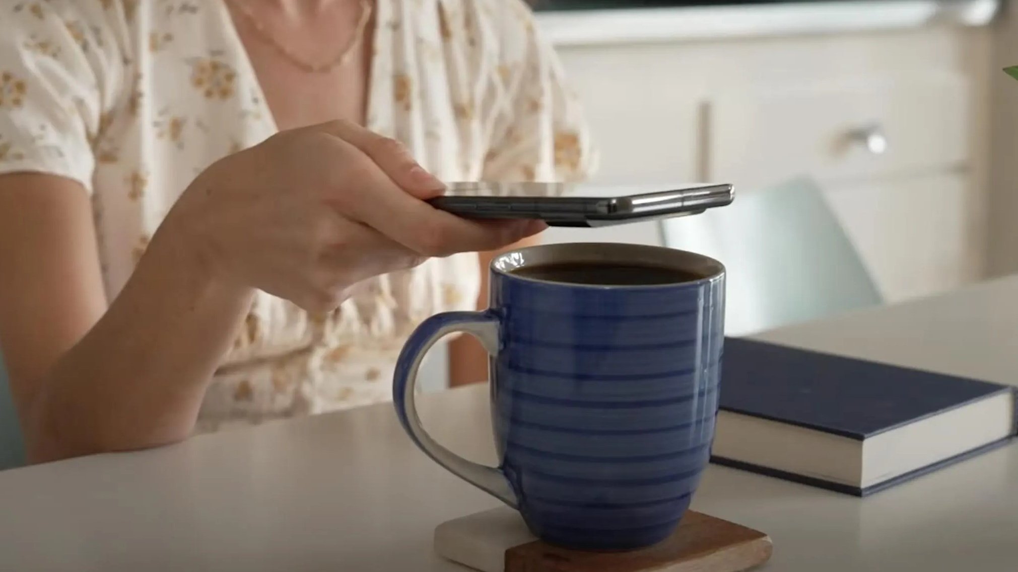 Woman using Google Pixel 8 Pro on her coffee