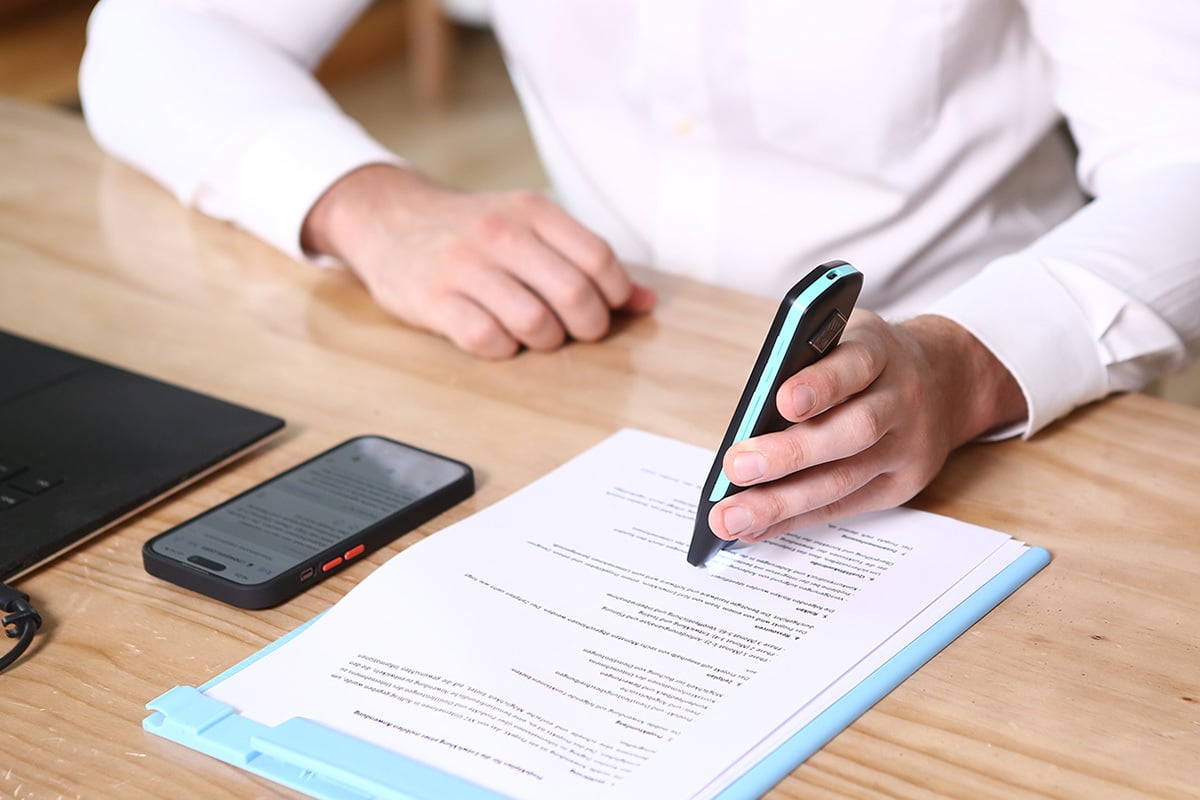 person using scanner on document