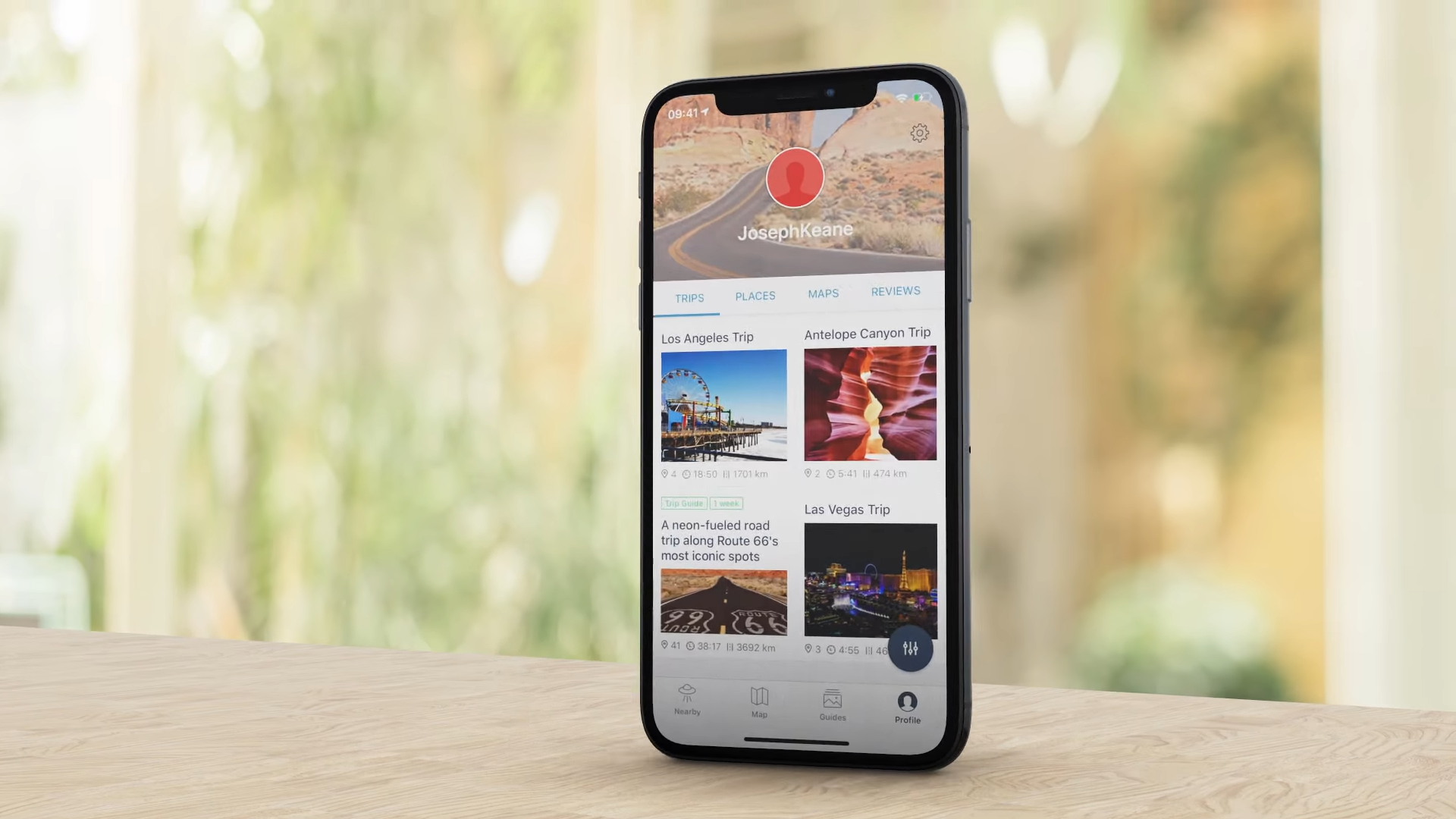 Roadtrippers UI on a phone that's balanced on a table