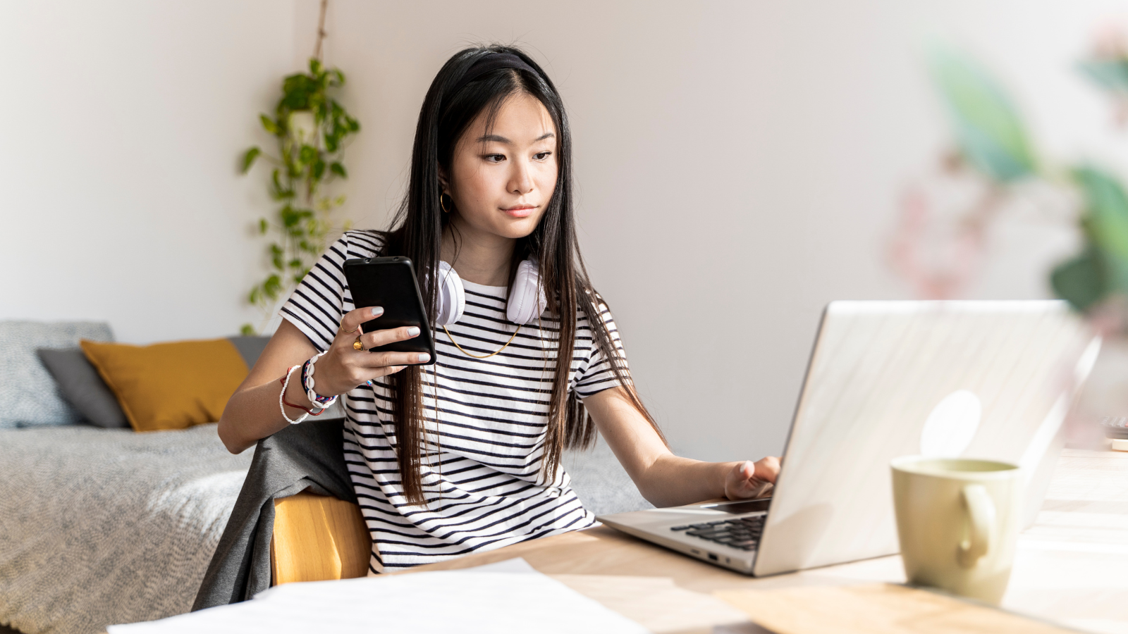 woman using phone and laptop at the same time