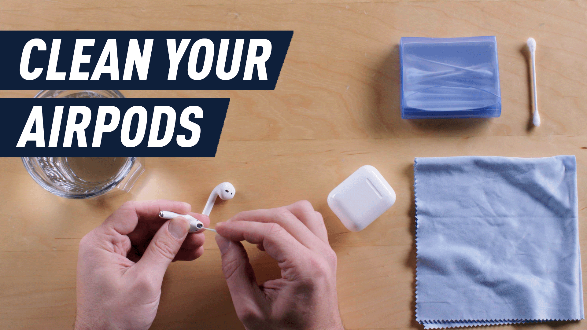 hands cleaning airpods with cotton swab
