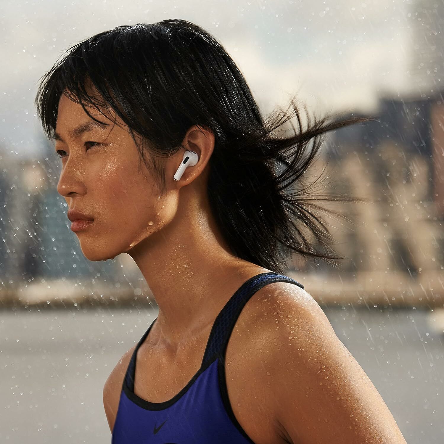 Woman wears Apple AirPods in the rain