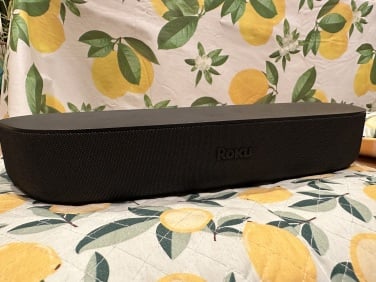 the roku streambar soundbar on lemon-print quilt