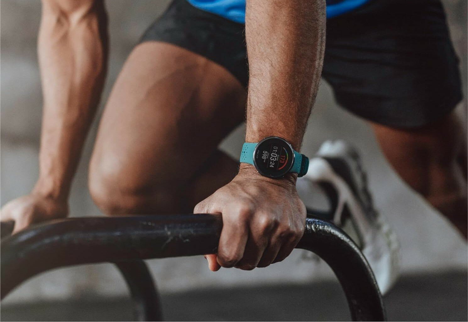a person working out wearing a teal colored polar pacer pro running watch on their left hand