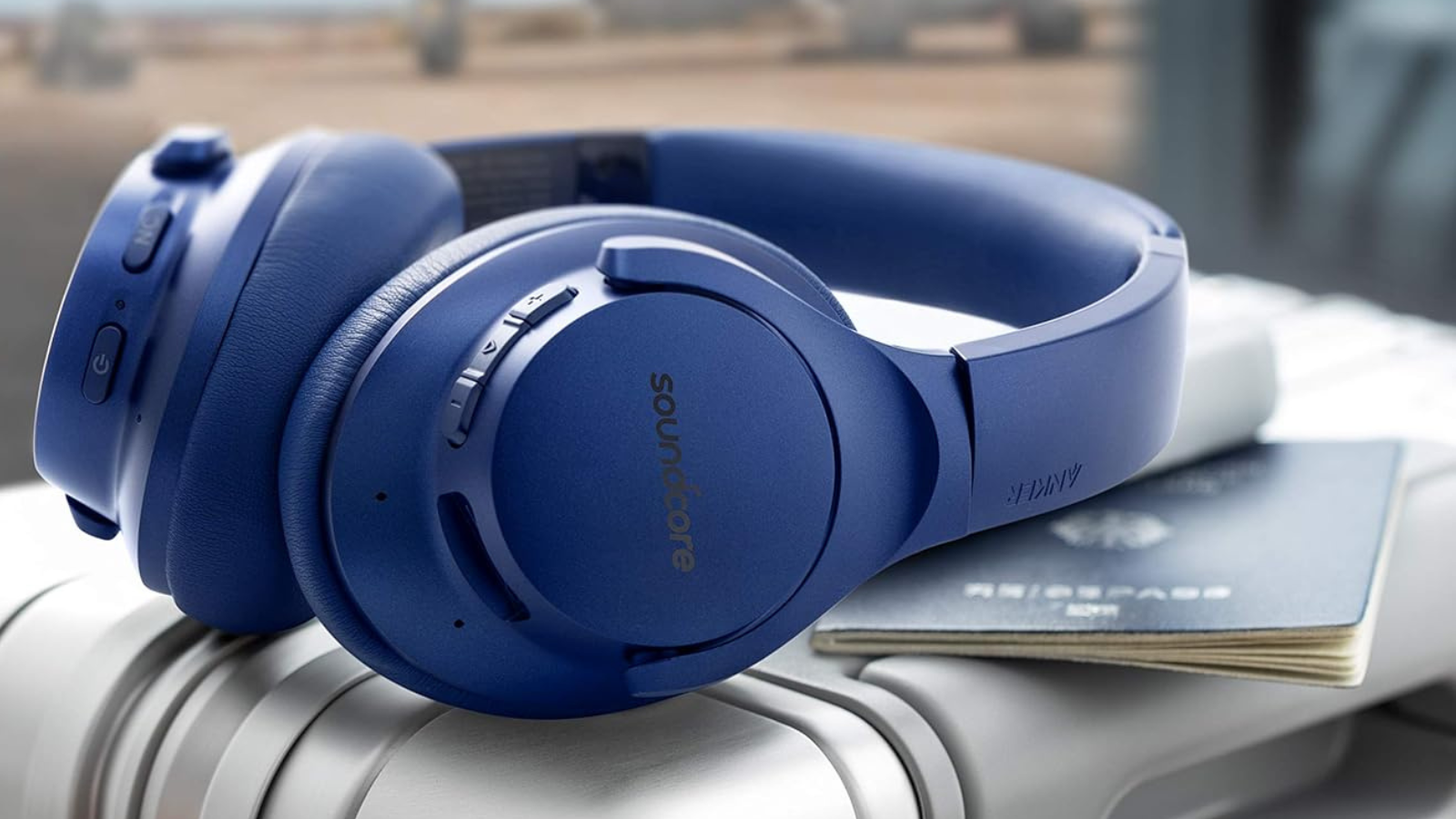 Soundcore Life Q20 headphones laying on suitcase with passport