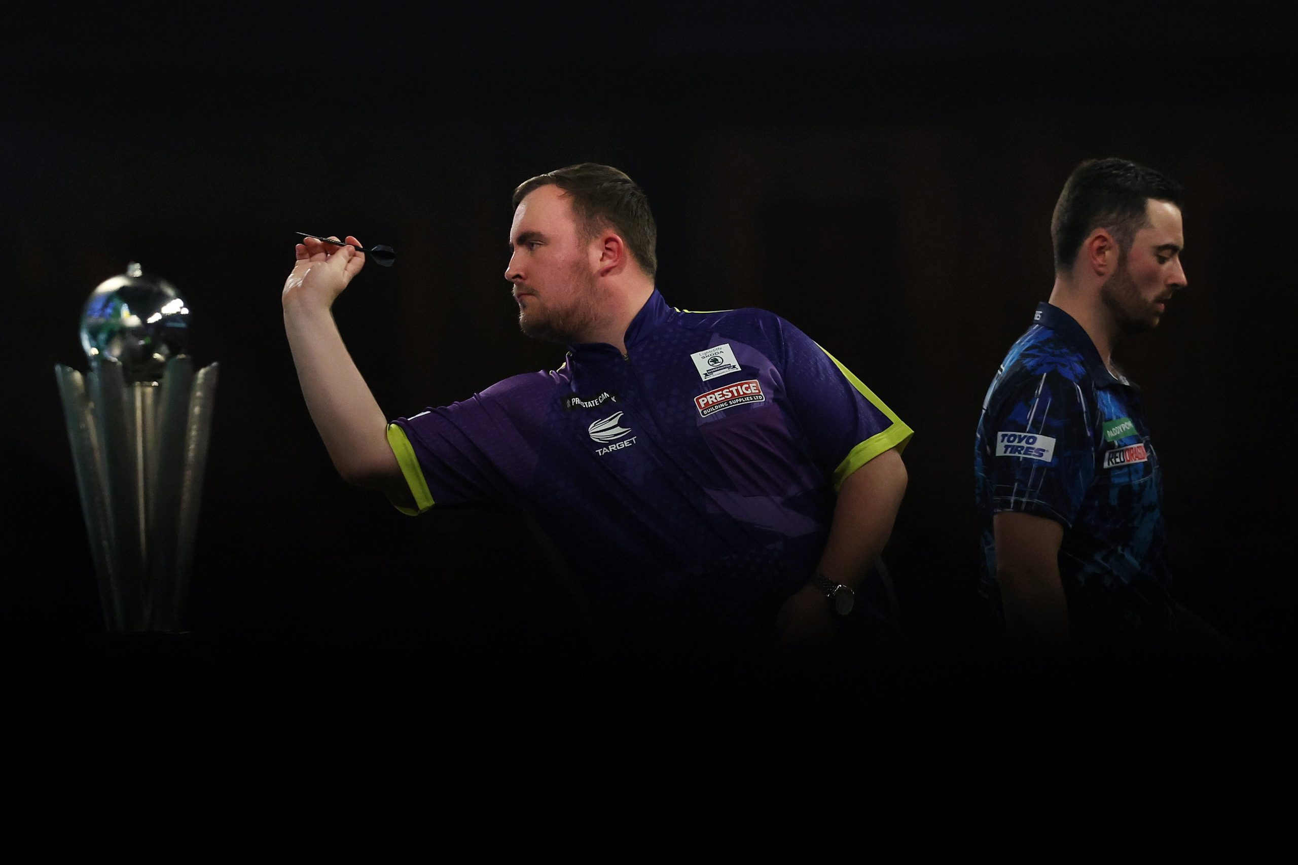 Luke Littler of England throws