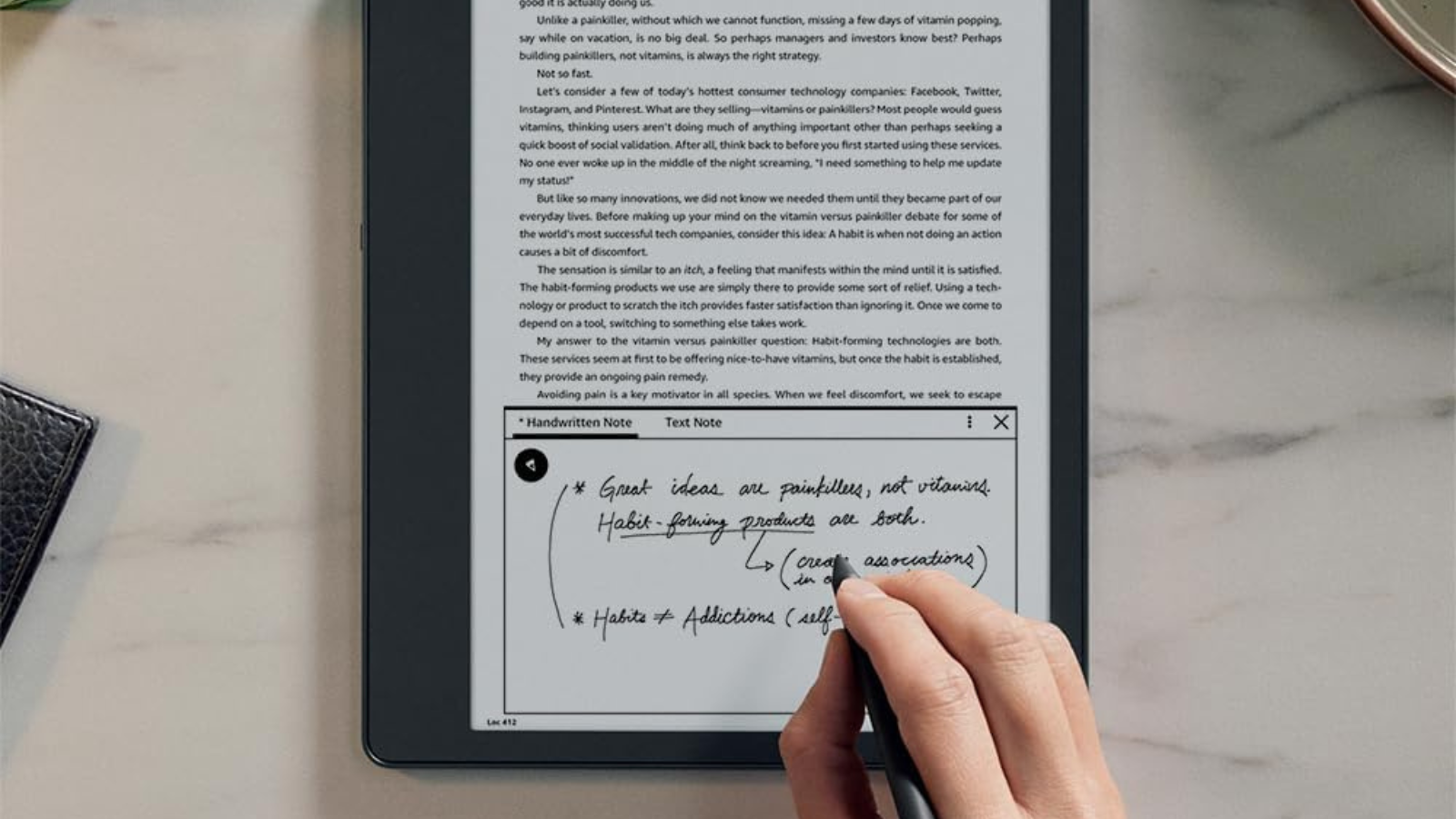 person taking notes on Kindle Scribe