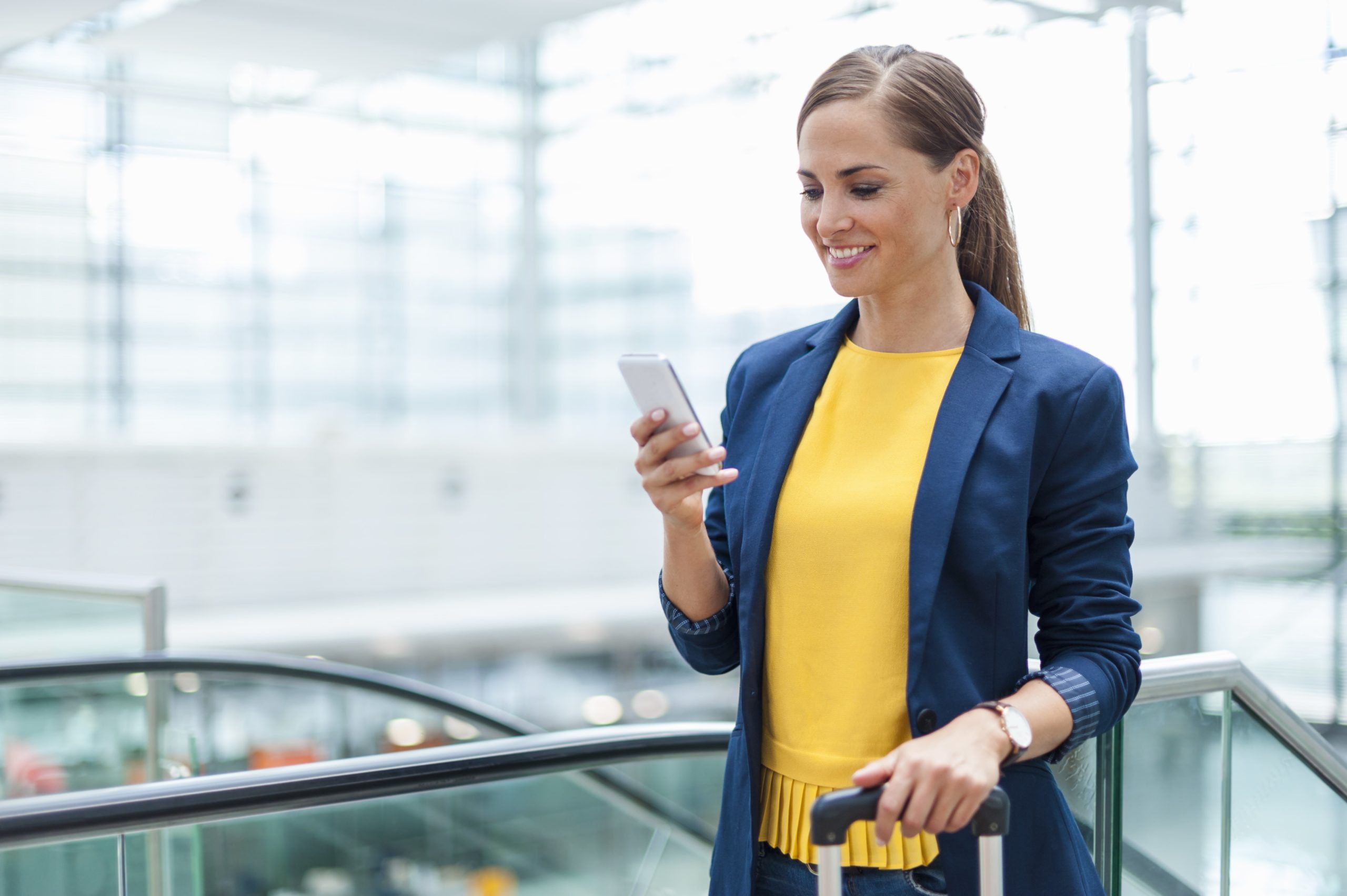 woman using phone in an airport
