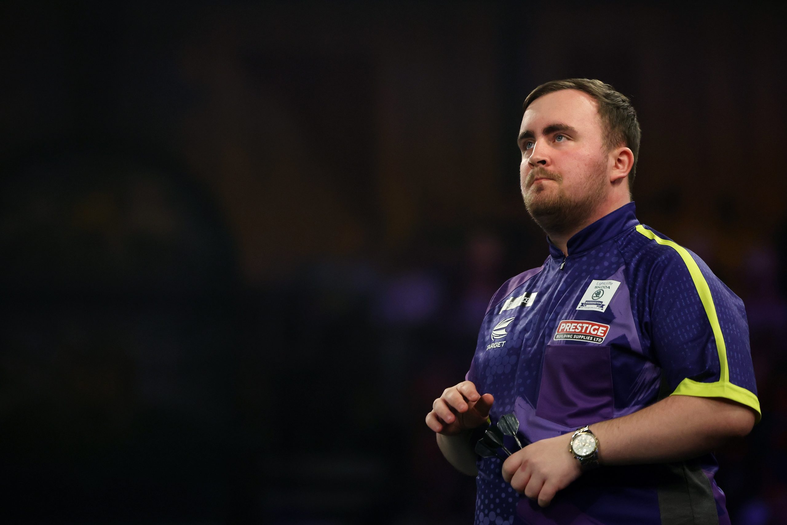 Luke Littler of England looks on