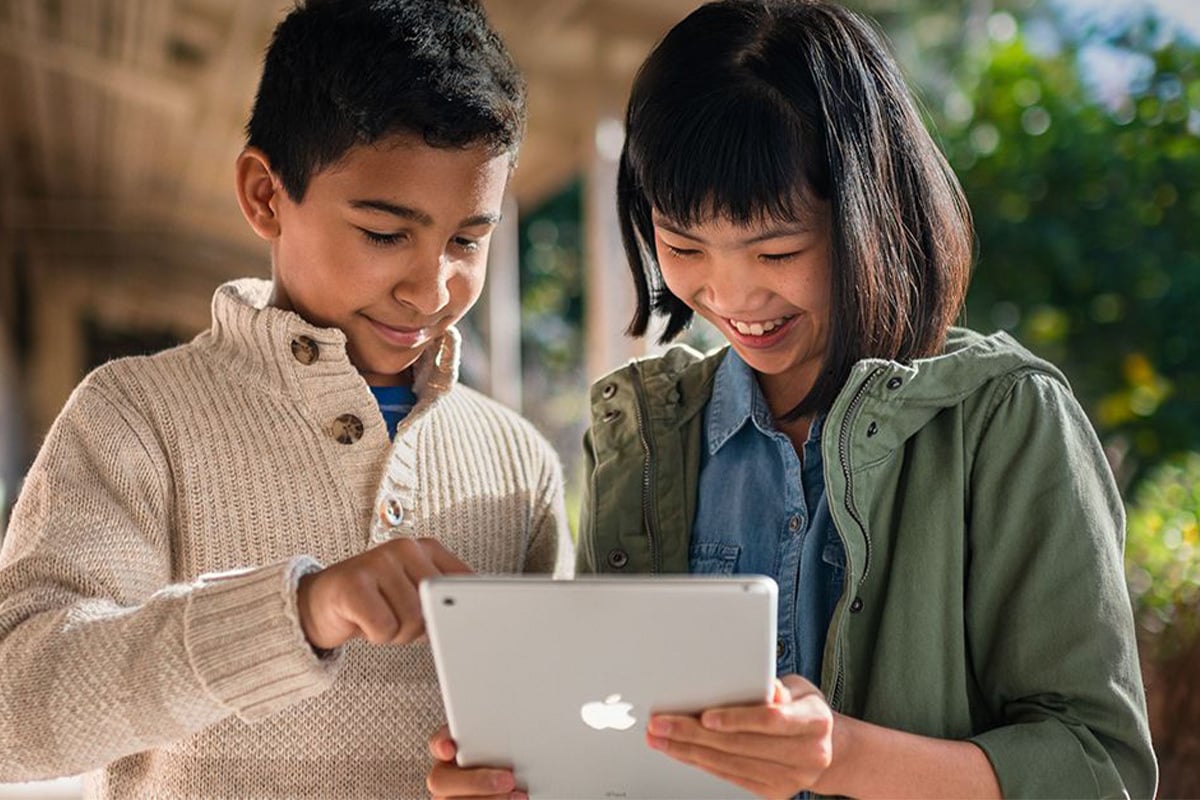 two children using an iPad