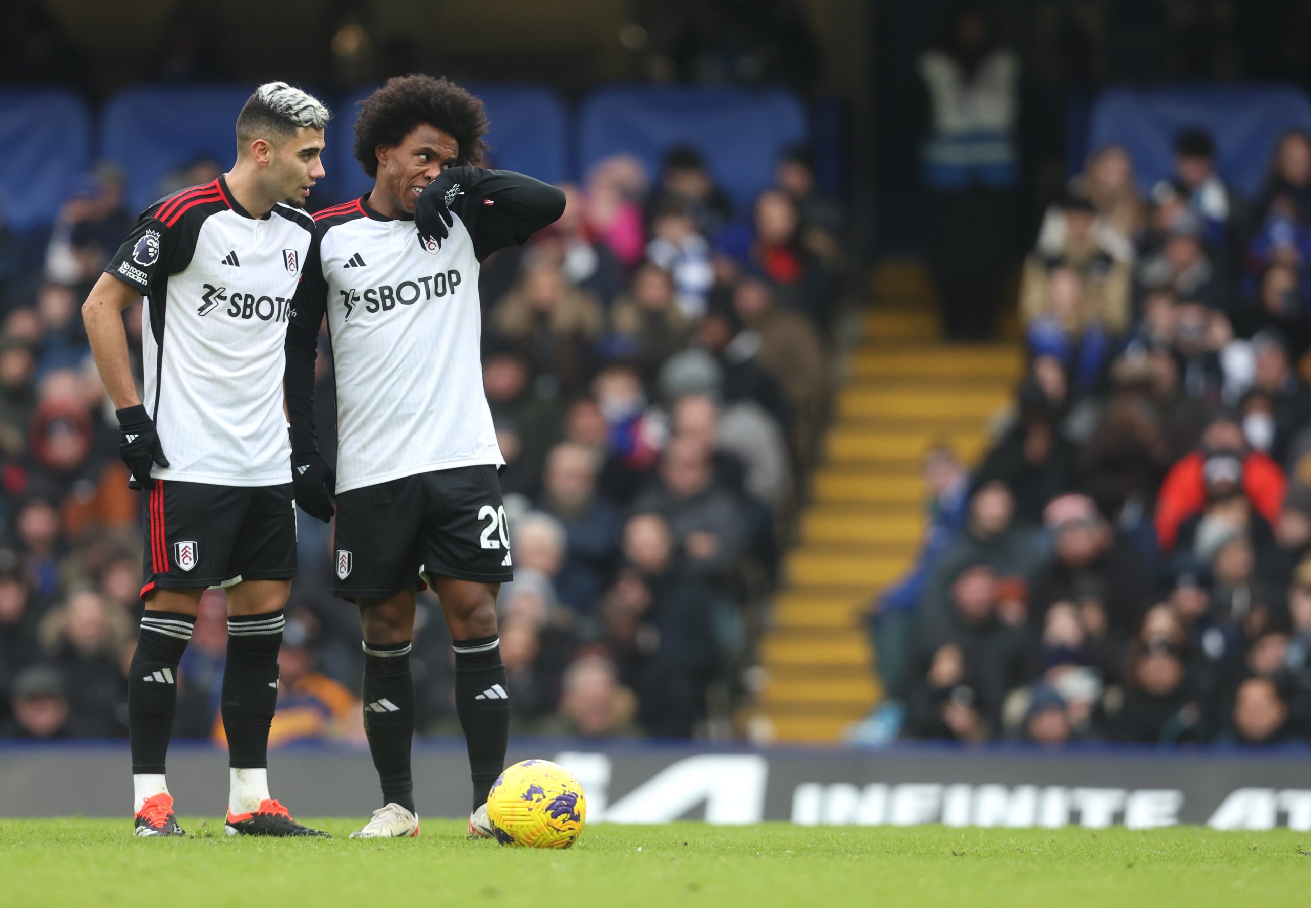 Andreas Pereira and Willian prepare to take a free-kick