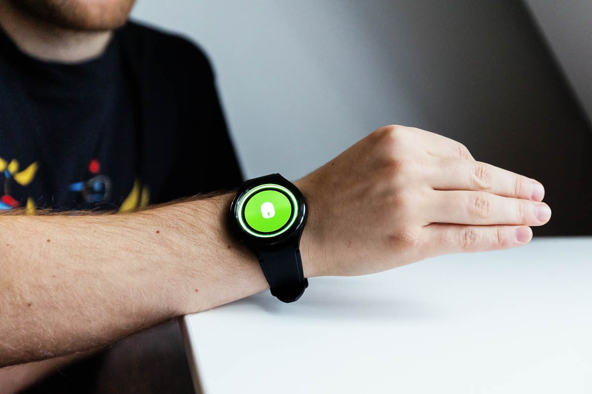 white man wearing a watch with a green screen