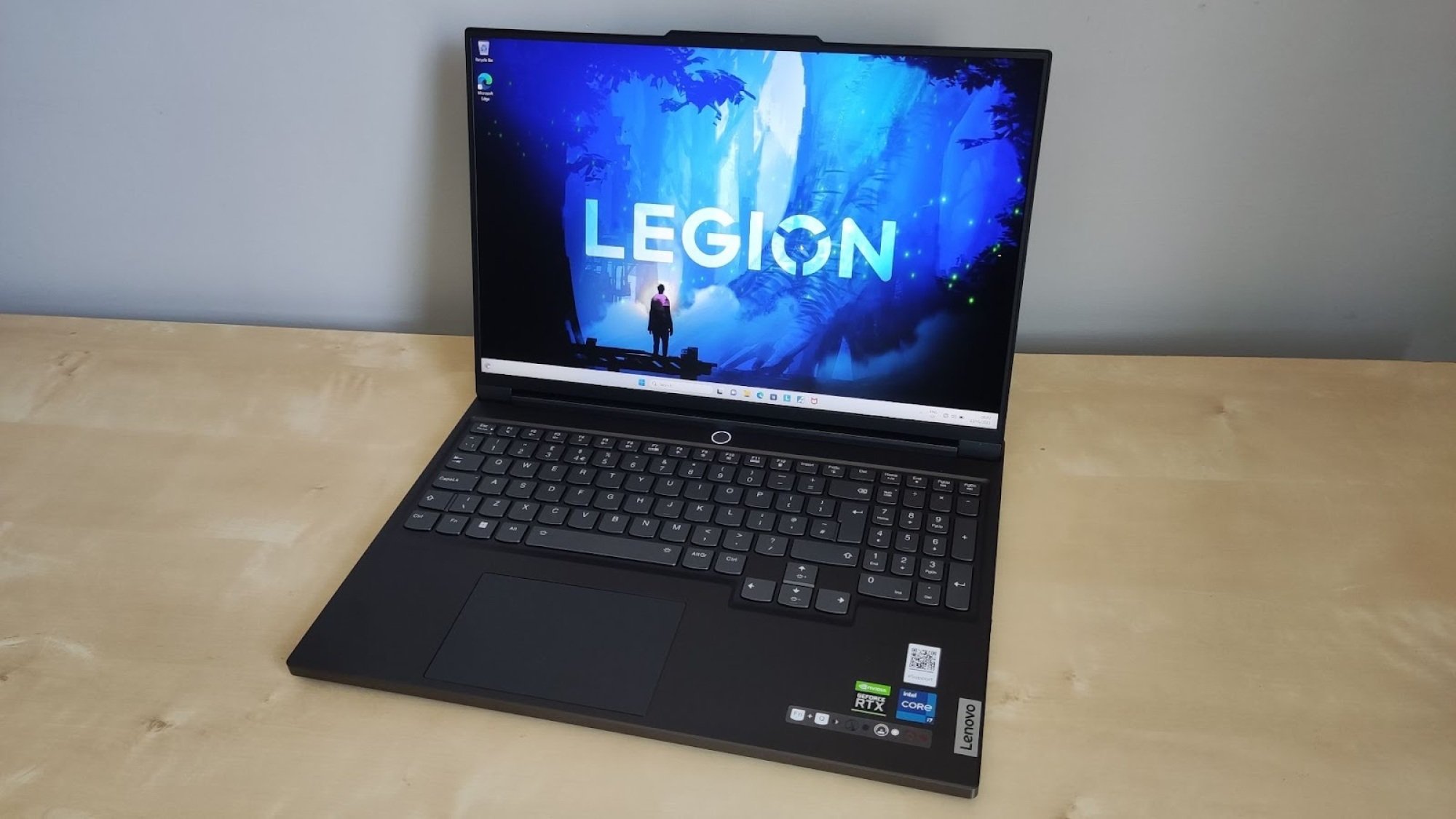 Lenovo Legion gaming laptop on desk with "LEGION" on screen
