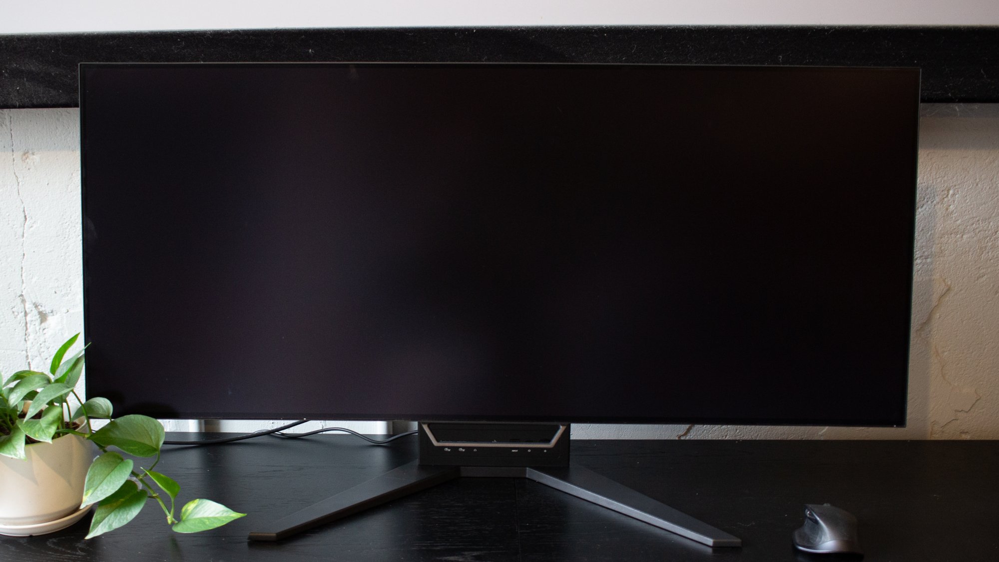 wide monitor in flat position with screen turned off