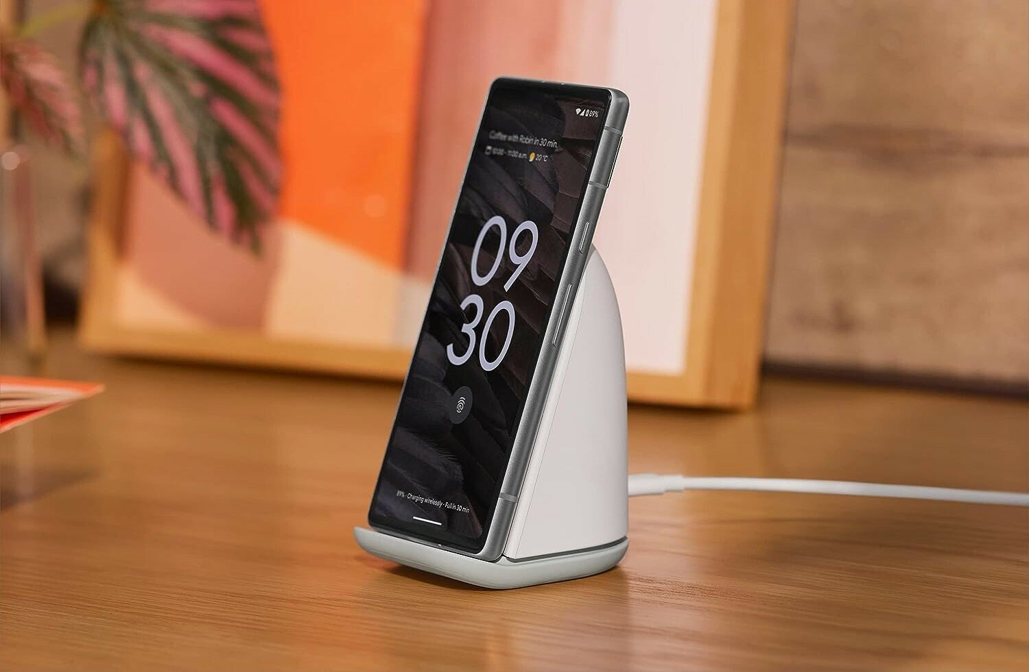 a google pixel 7a sits on a charger on a table