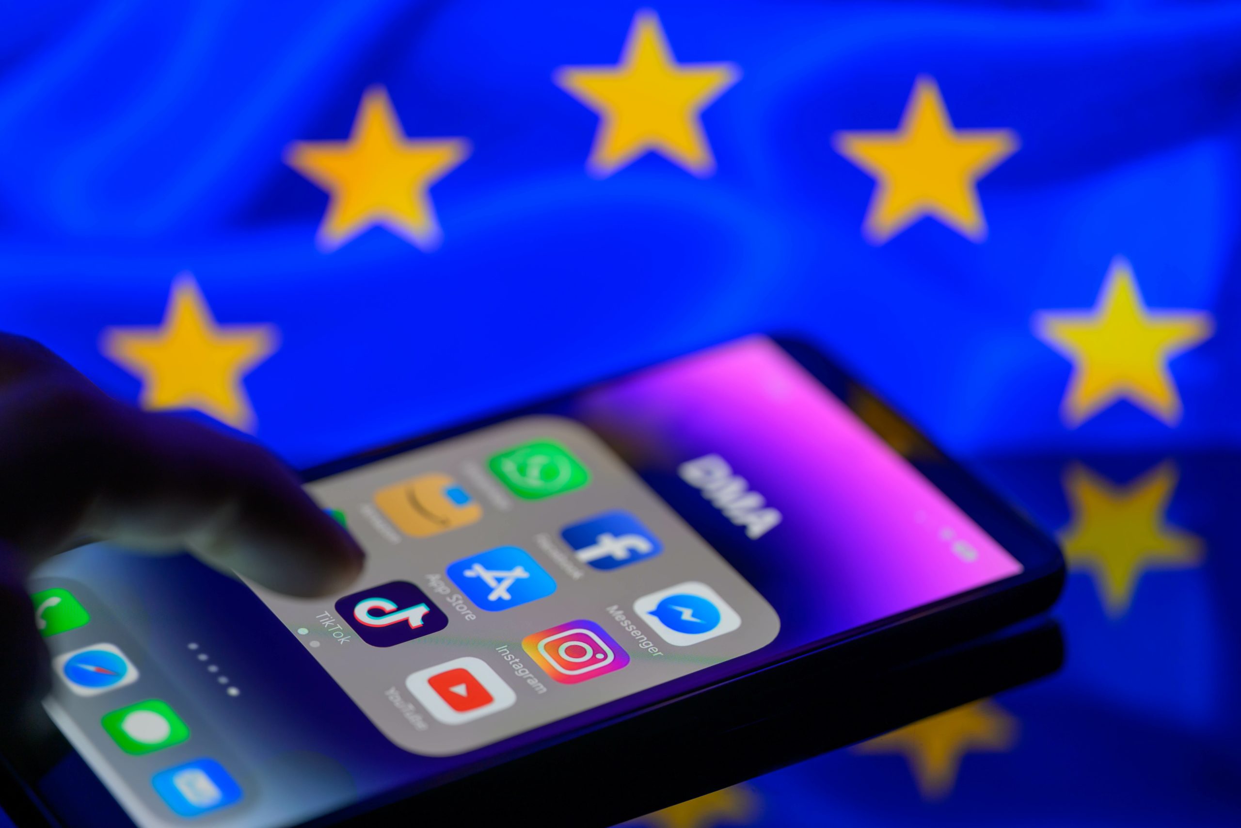 TikTok app on phone screen with the EU flag in the background.