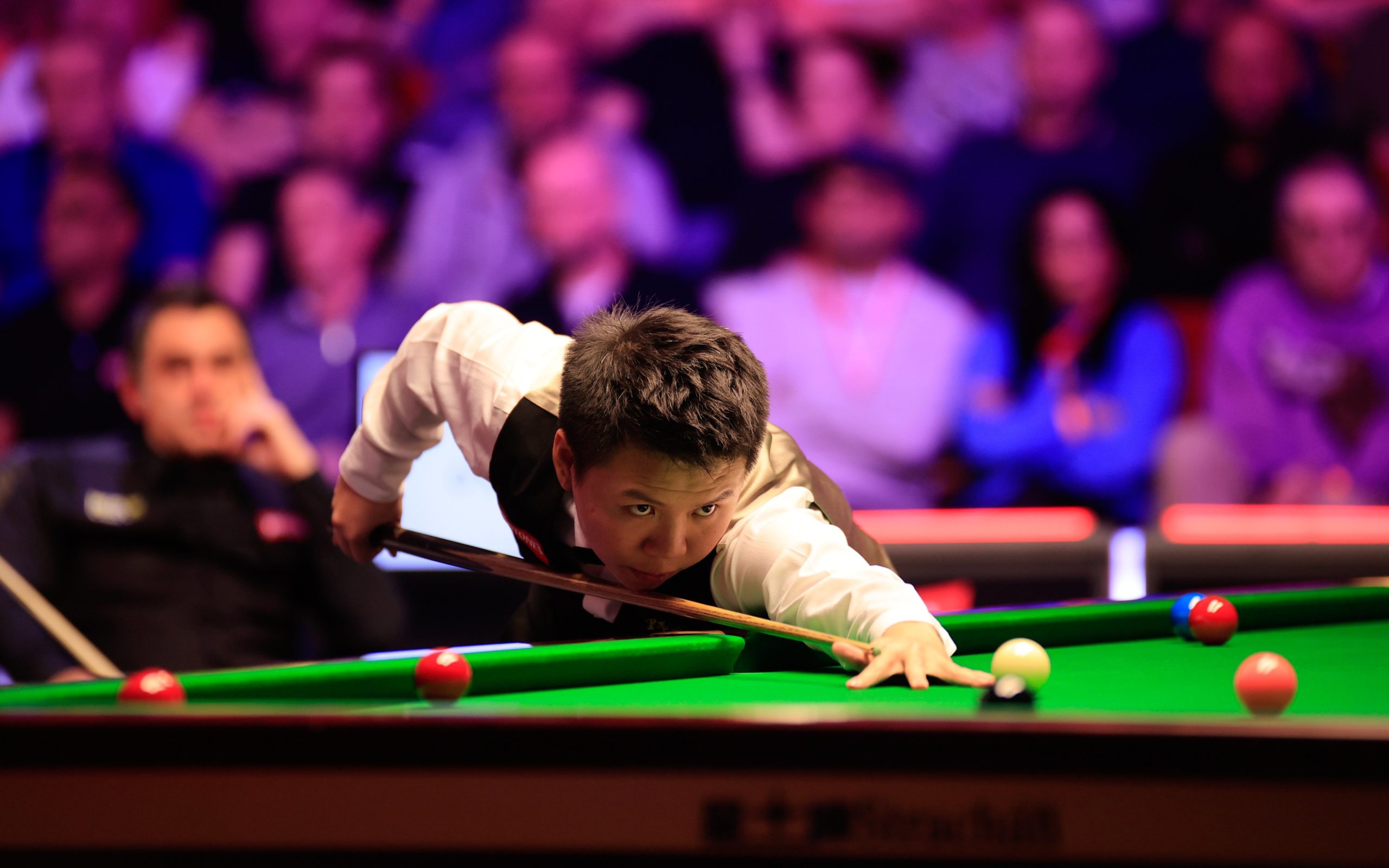 Zhou Yuelong of China plays a shot