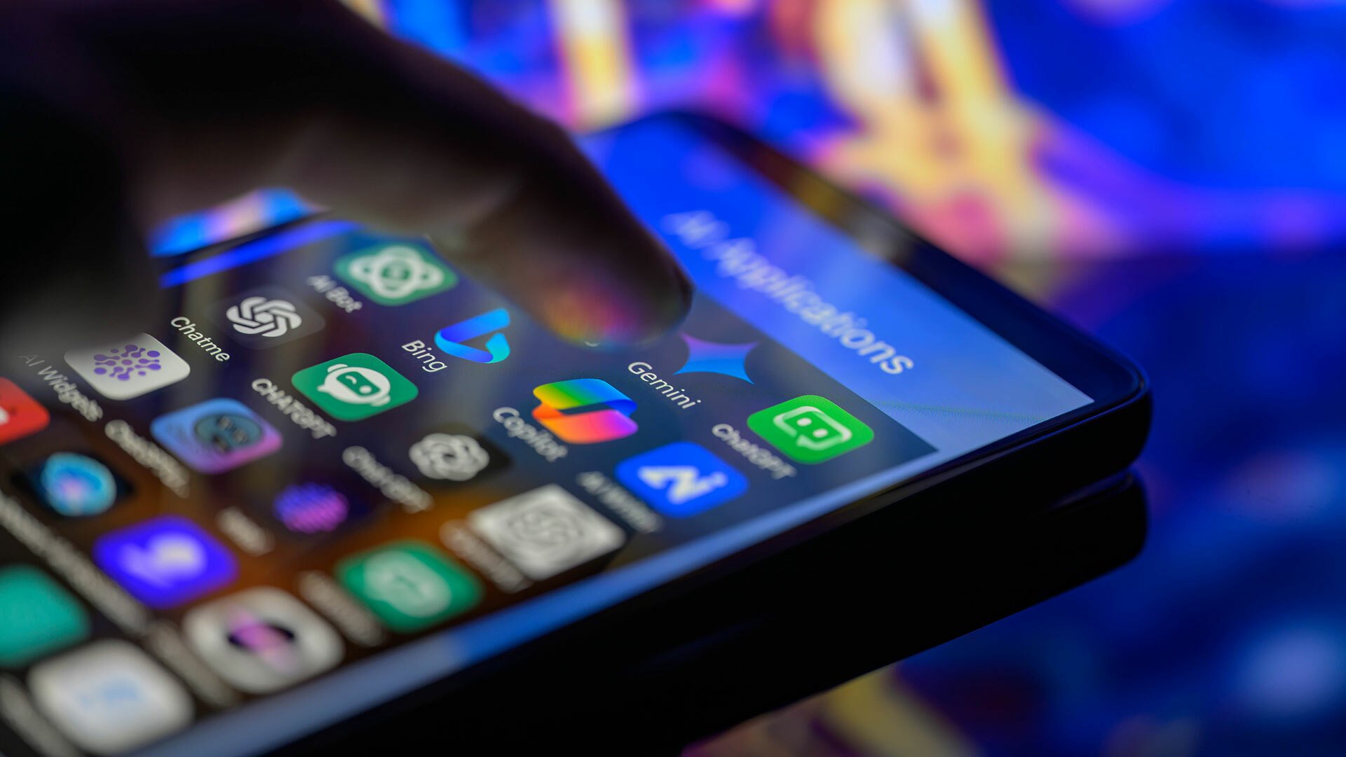 A close-up of a smartphone shows a finger about to touch the Gemini app.