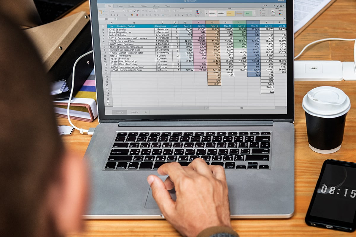 man editing Excel spreadsheet