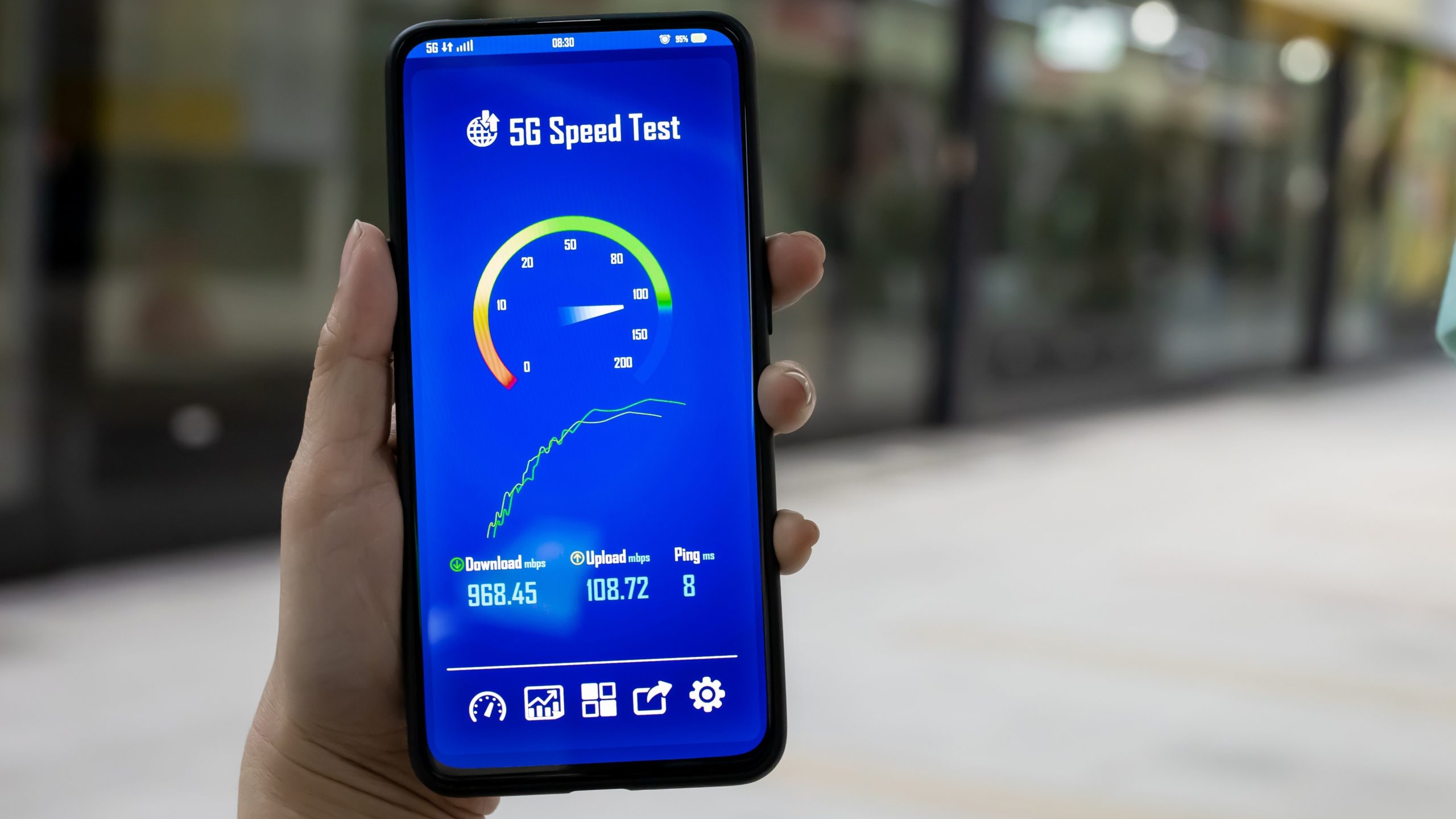 Person holding a phone with speed test