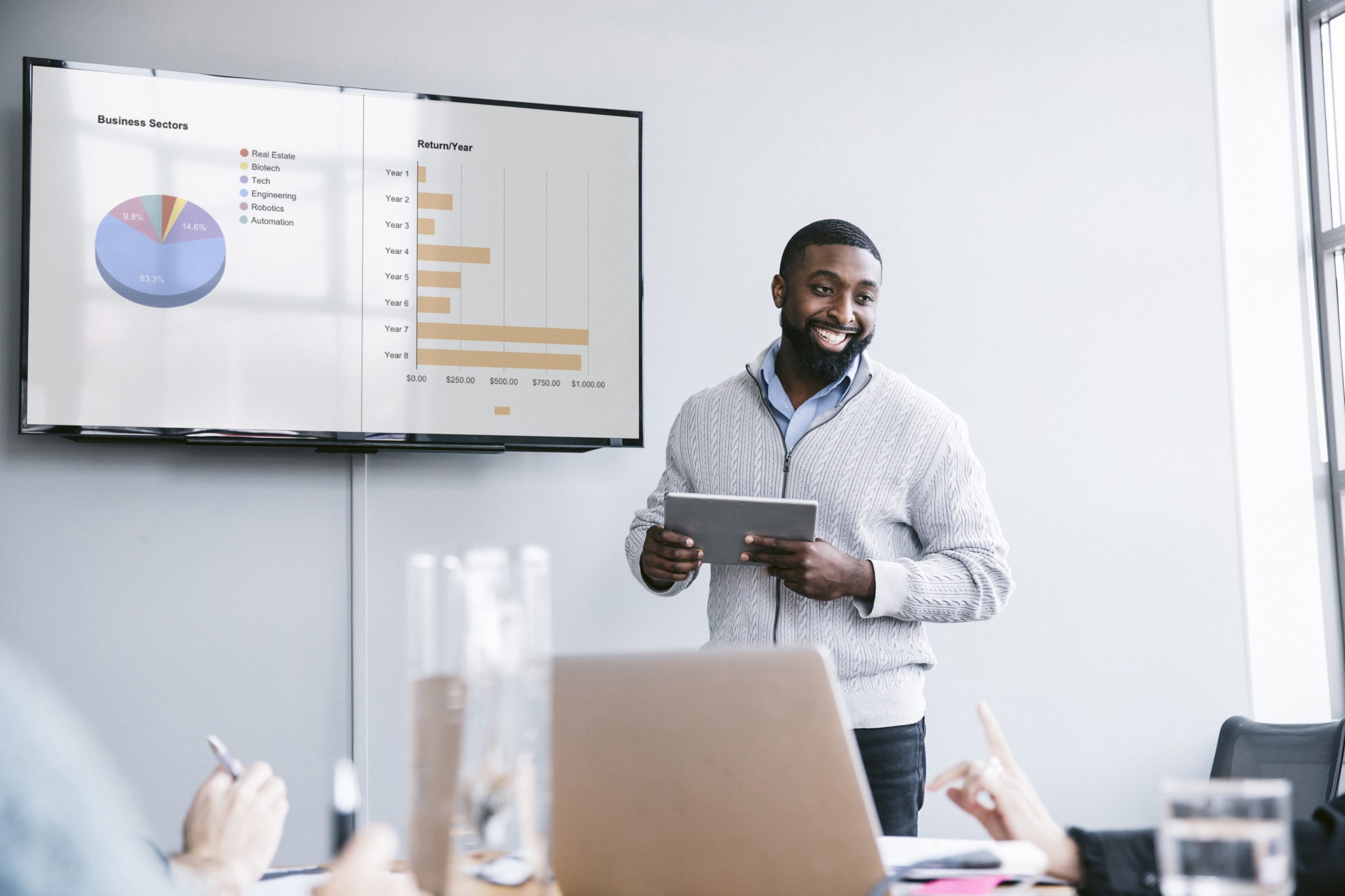 man presenting data at a meeting