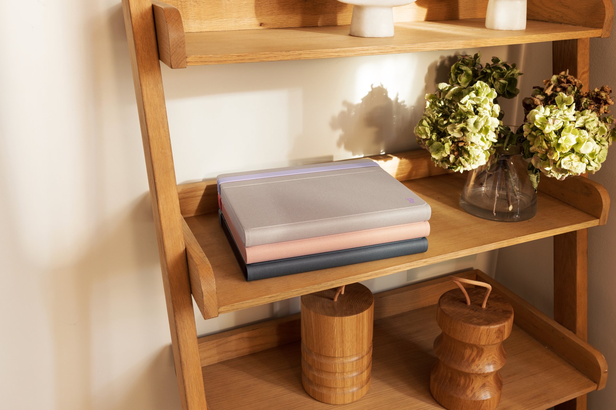 three casa pop-up desks folded up on a bookshelf
