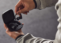 person taking Beats Powerbeats Pro out of charging case