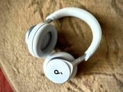 The Soundcore Space One headphones in a light blue color laying on carpeting