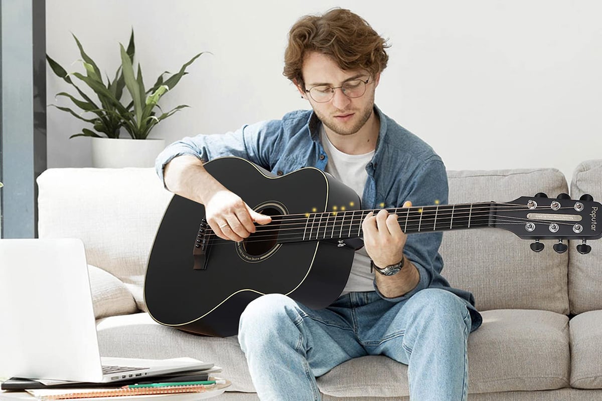 Man learning to play guitar