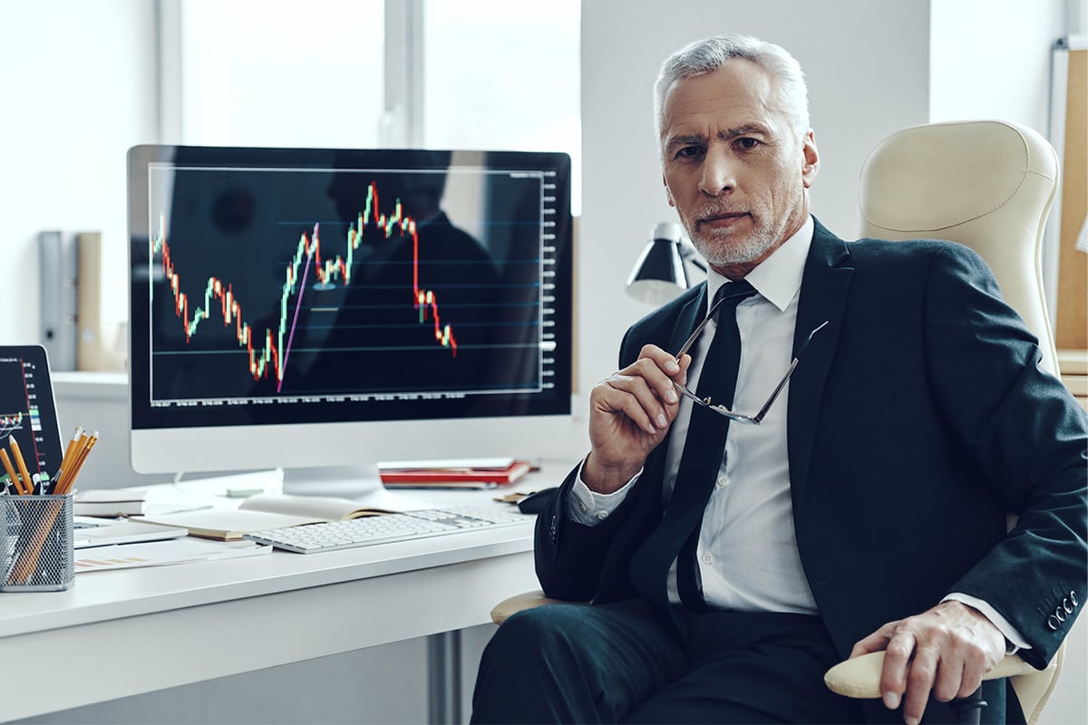 Person using computer to look at charts.
