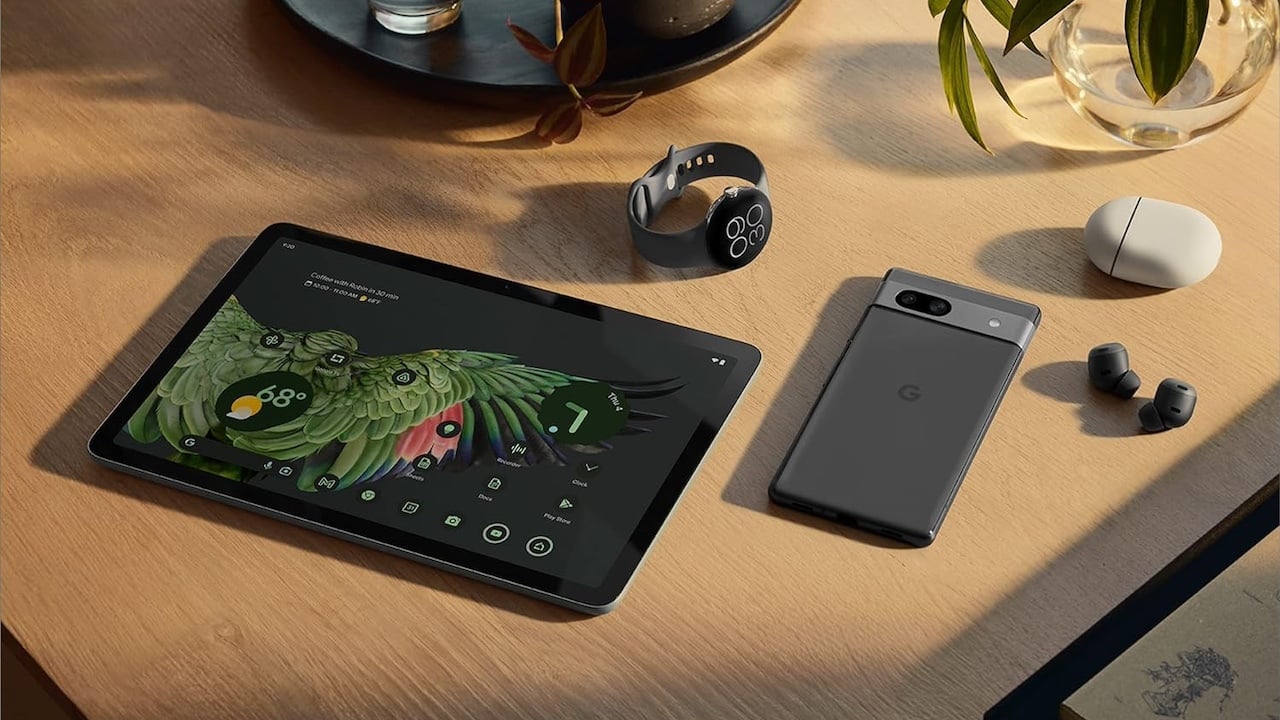 Google Pixel Tablet sitting on a table with other Google devices.