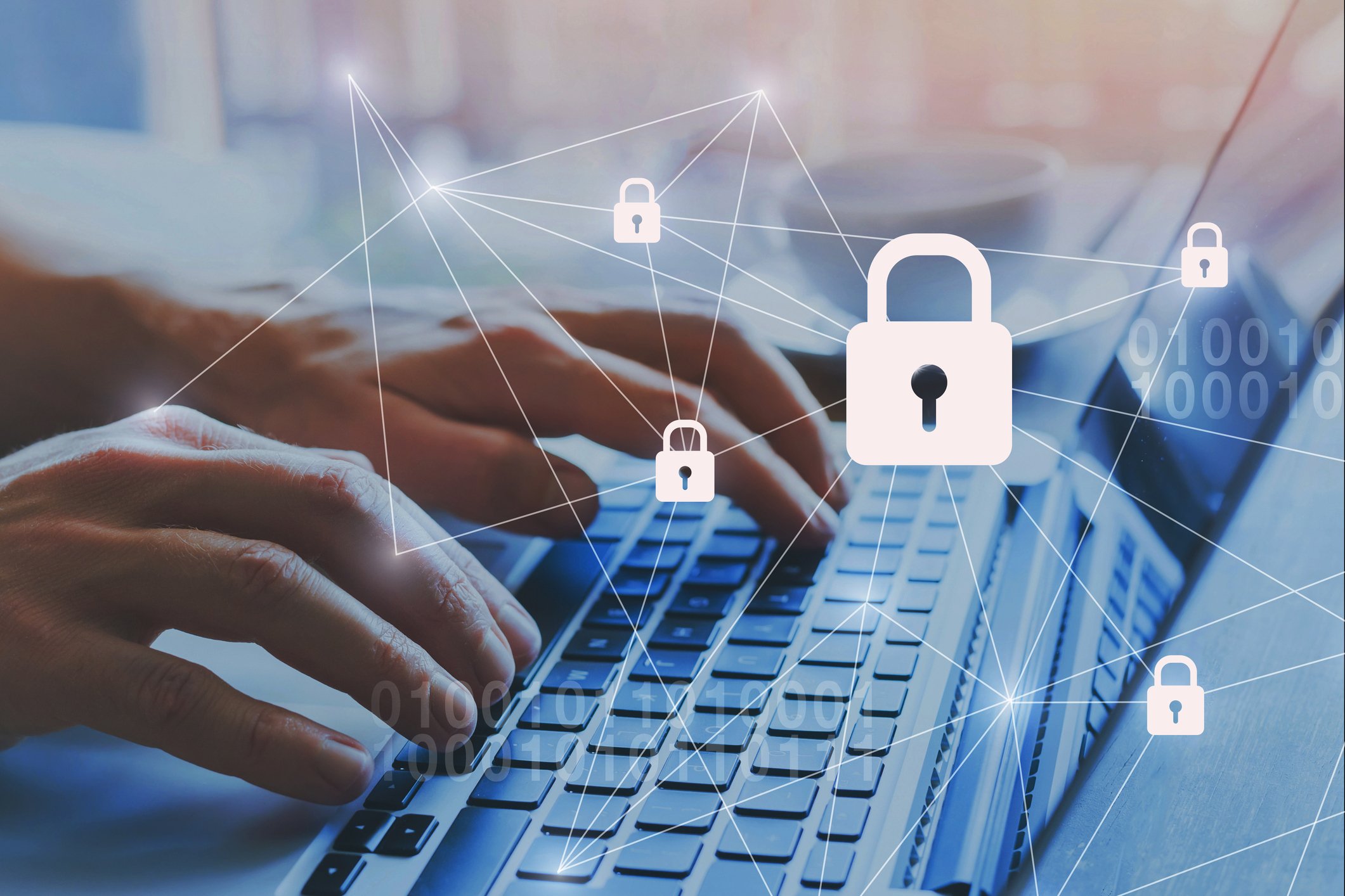 Hands on a laptop with data privacy illustrations happening above the keyboard
