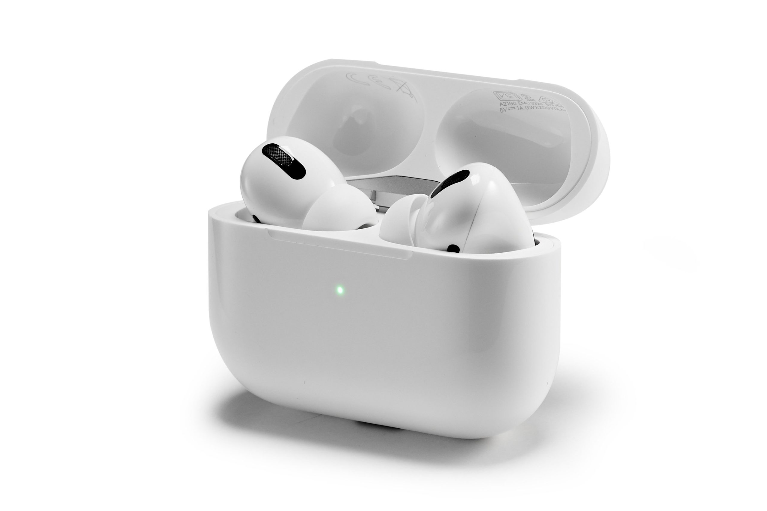 A pair of AirPods in their charging case, which is flipped open.