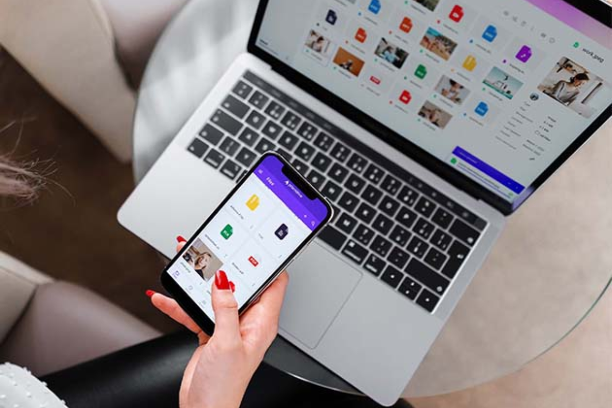 person using Prism app and laptop