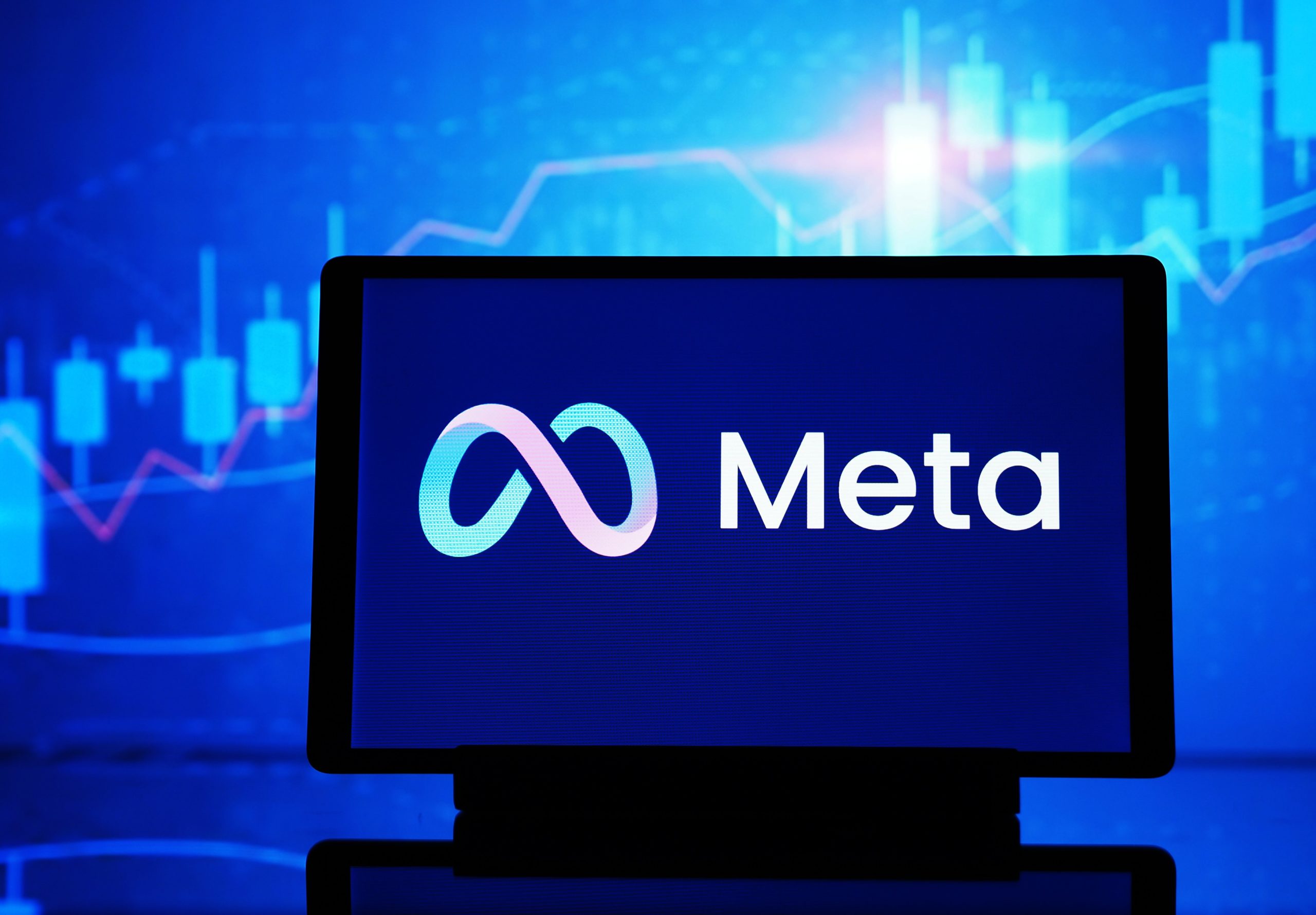 A computer displaying the Meta logo.