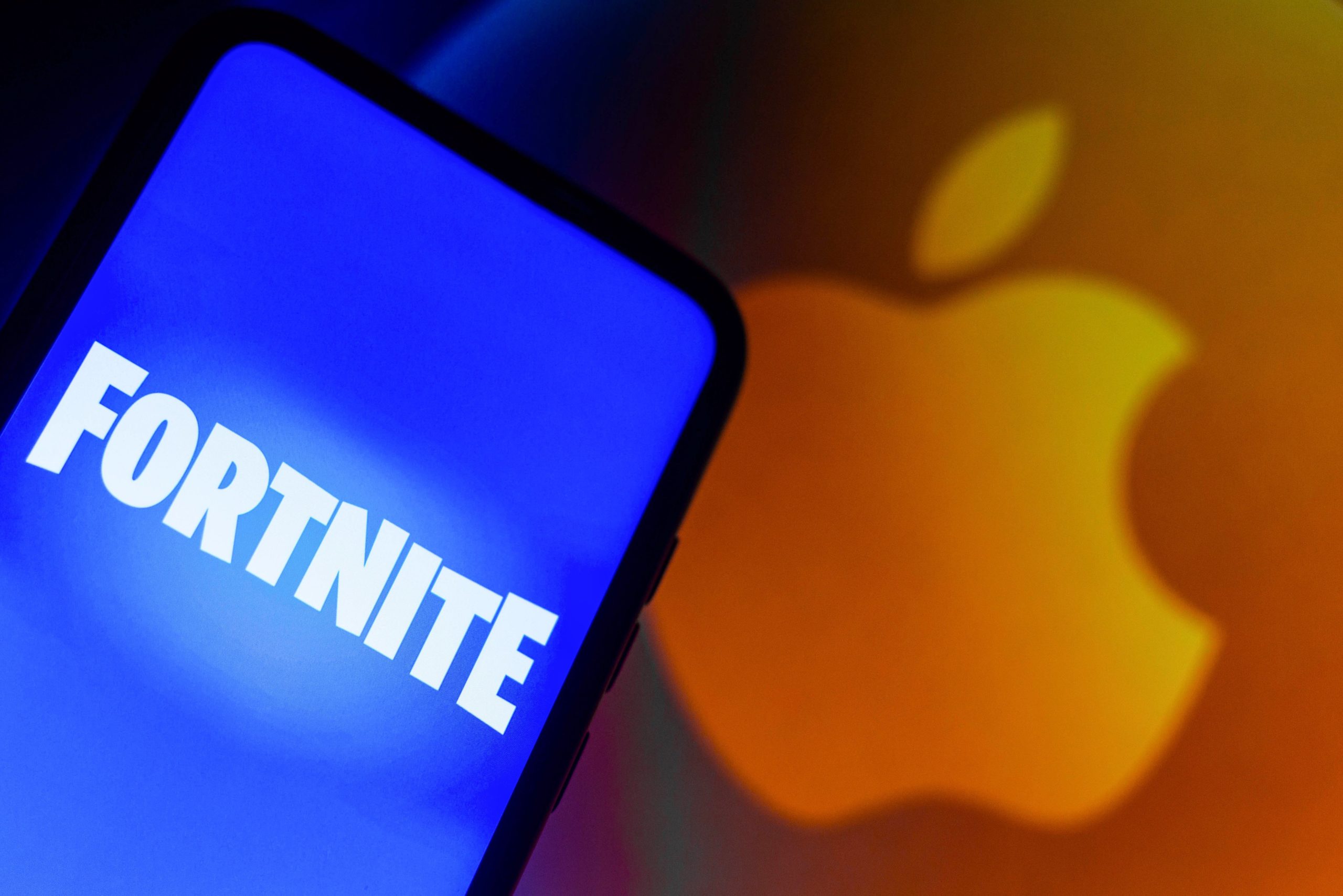 Fortnite on iPhone beside Apple logo
