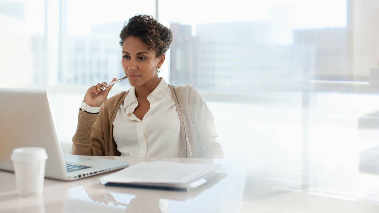 Person staring at laptop at desk