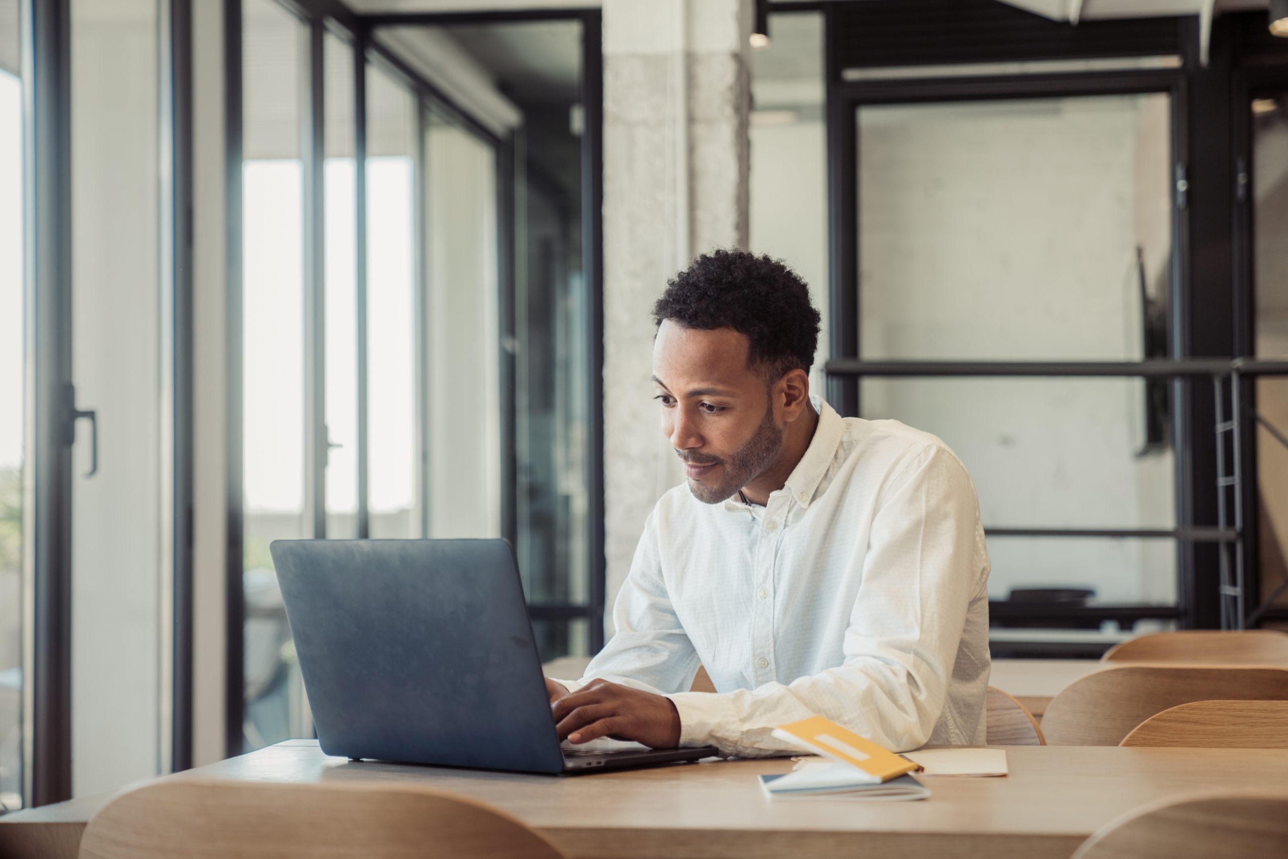 Man works on computer in office.
