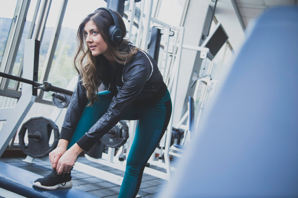 Woman at gym tying shoe