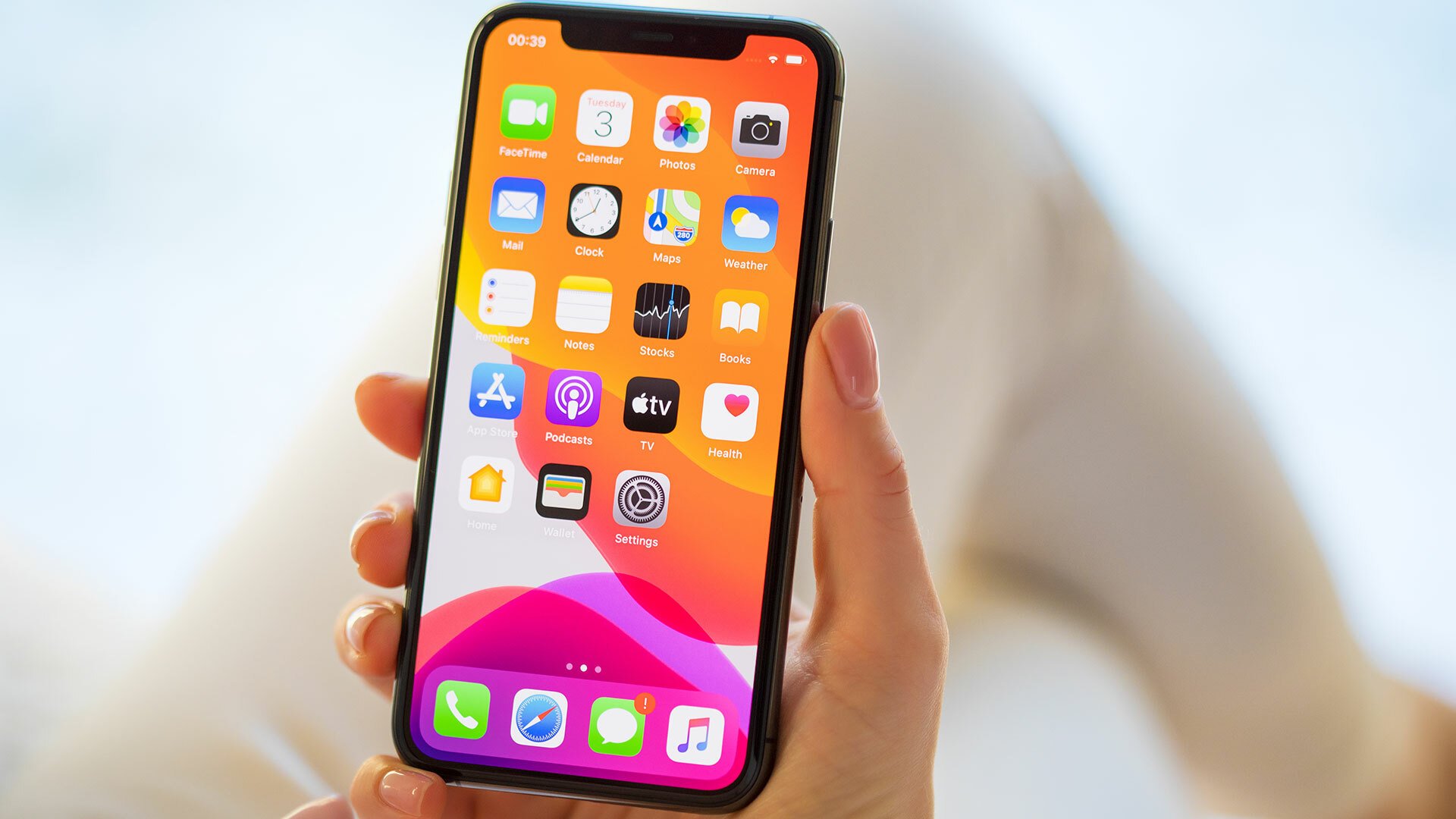 A close-up of a person holding an iPhone.