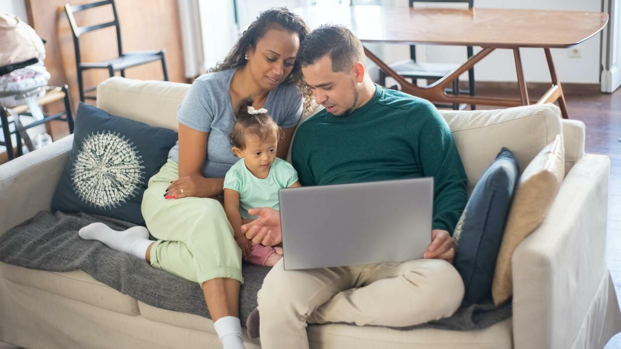 Family looking at laptop