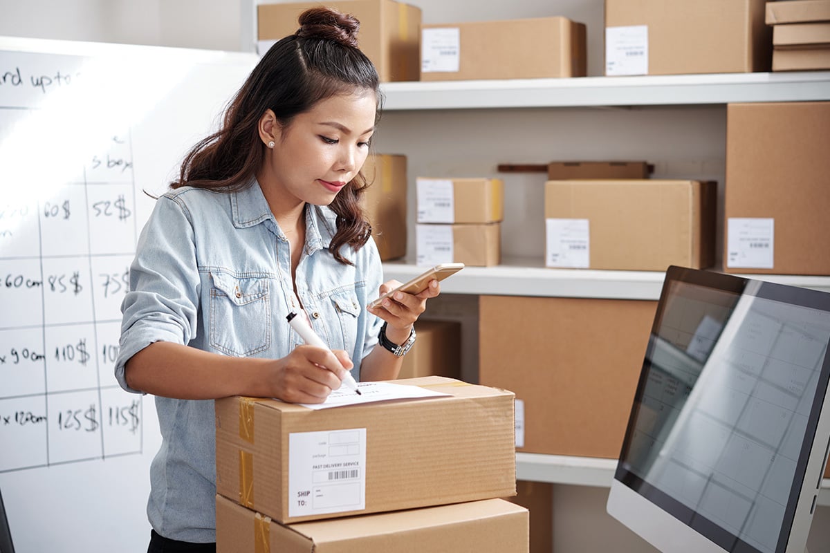 Woman prepping packages for delivery