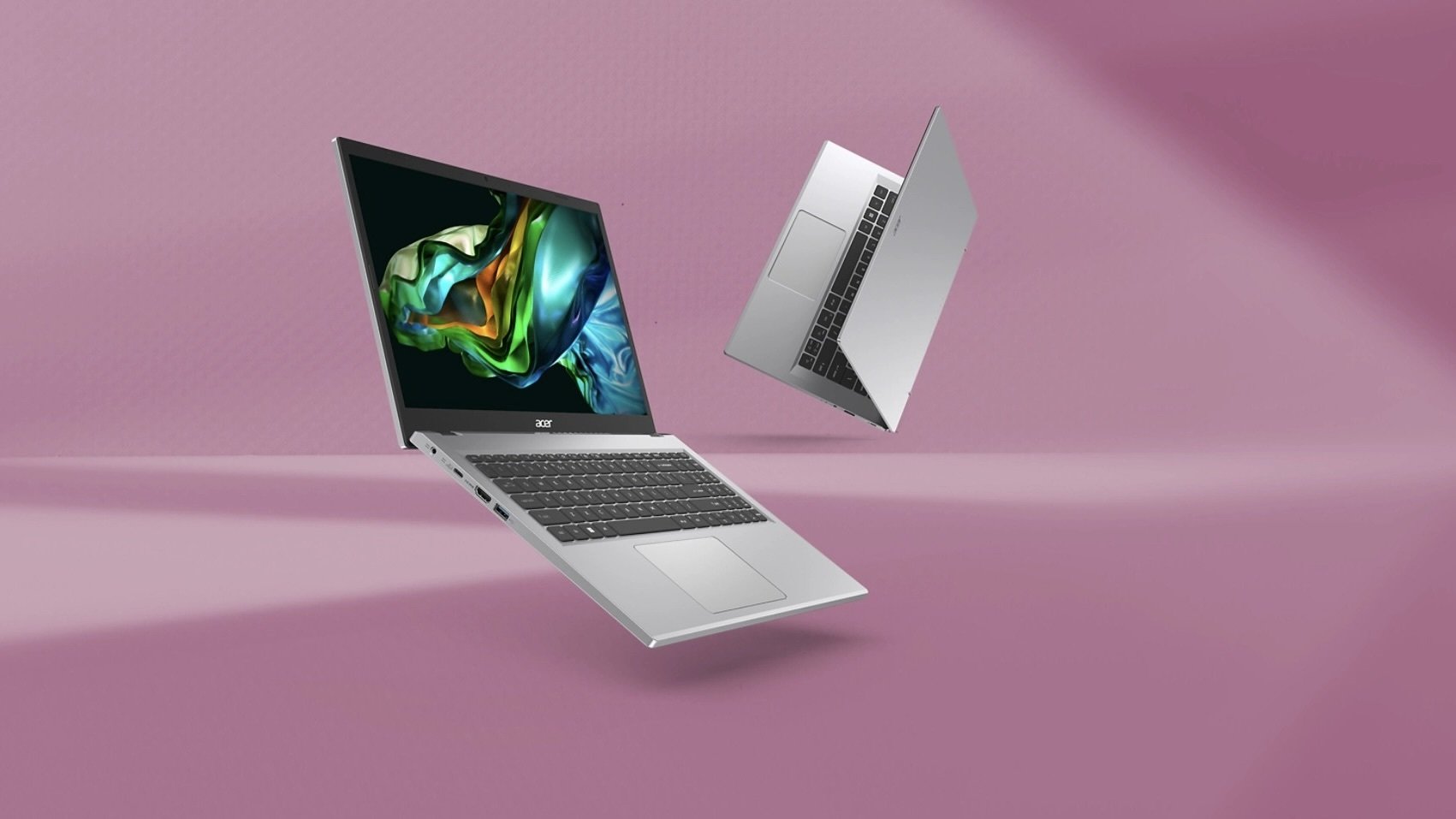 two acer aspire 3 laptops on a pink background