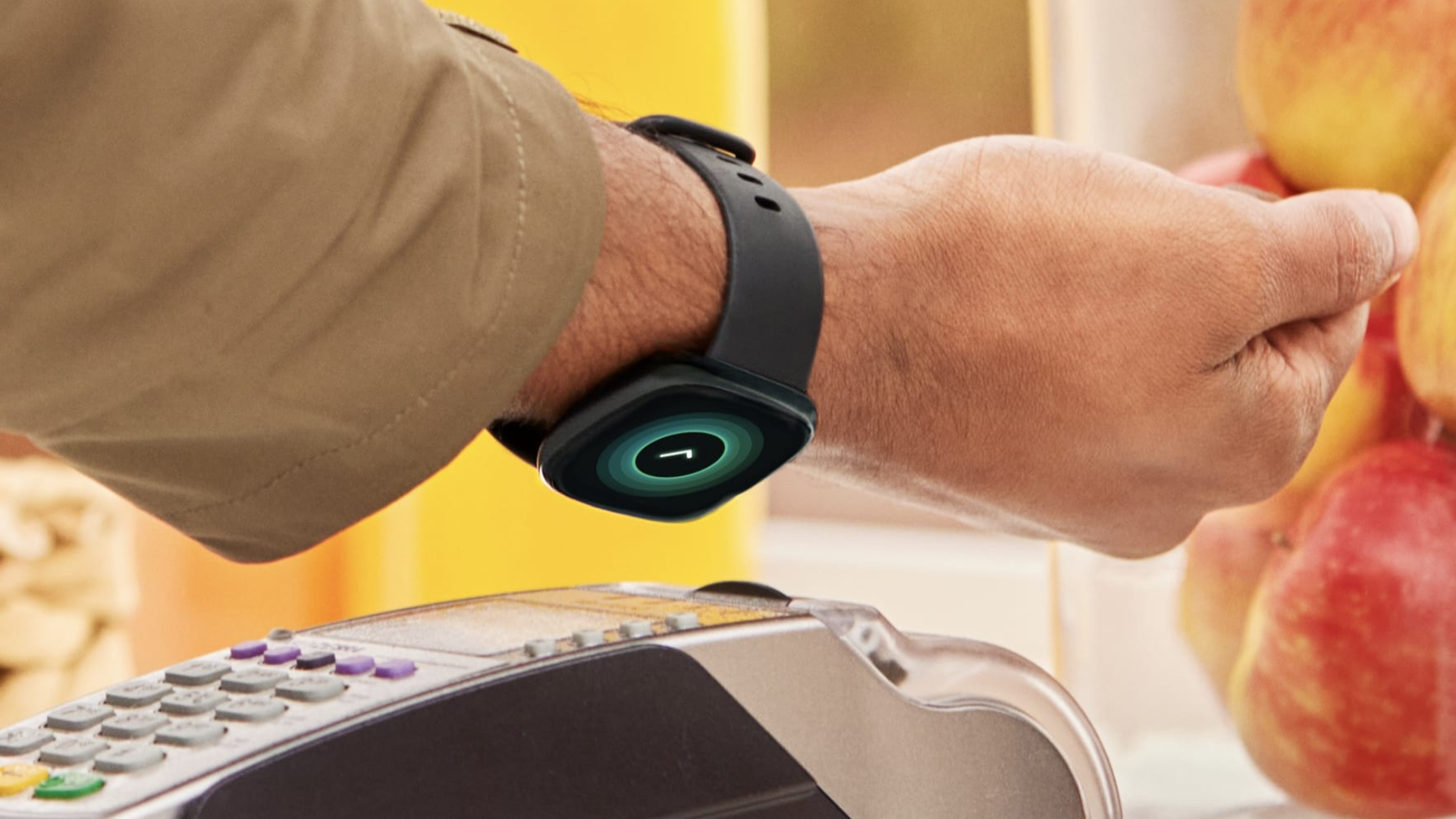 A person tapping their Fitbit Versa 4 to pay