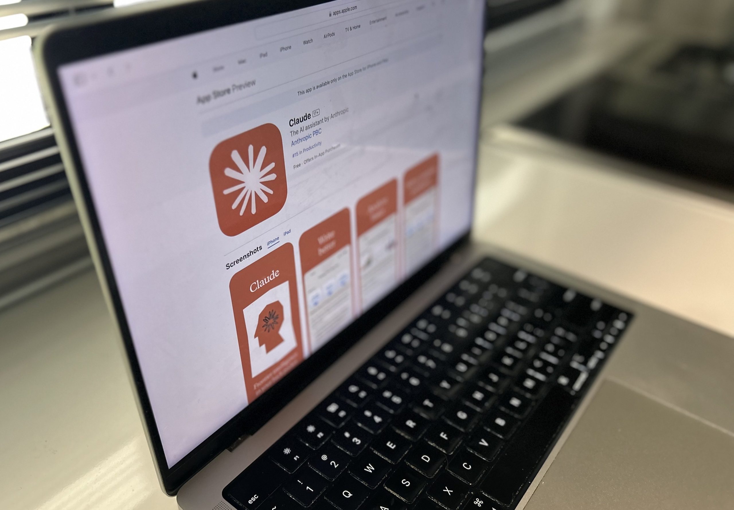 a laptop showing the Claude app in the App Store