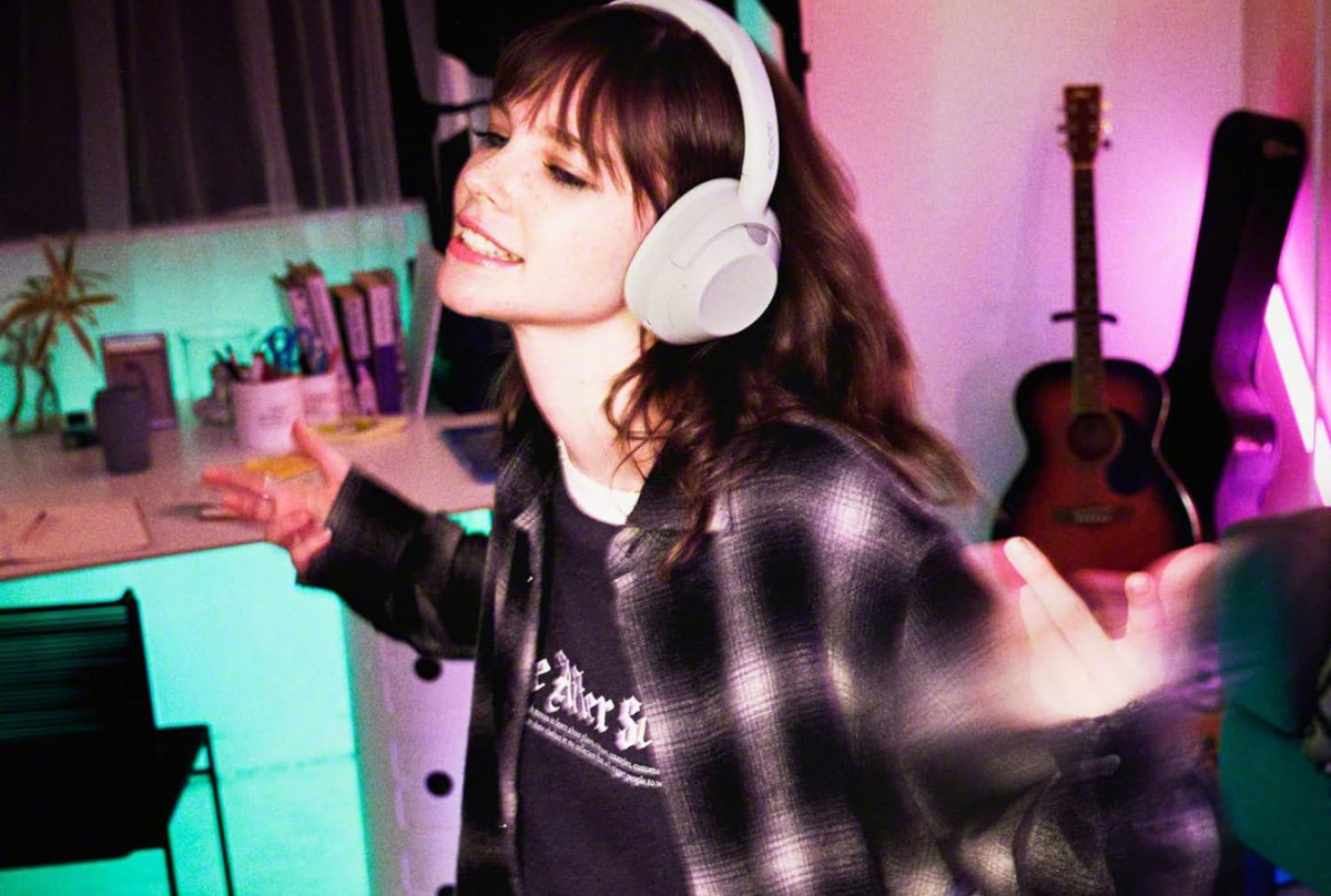 girl listening to music on sony headphones
