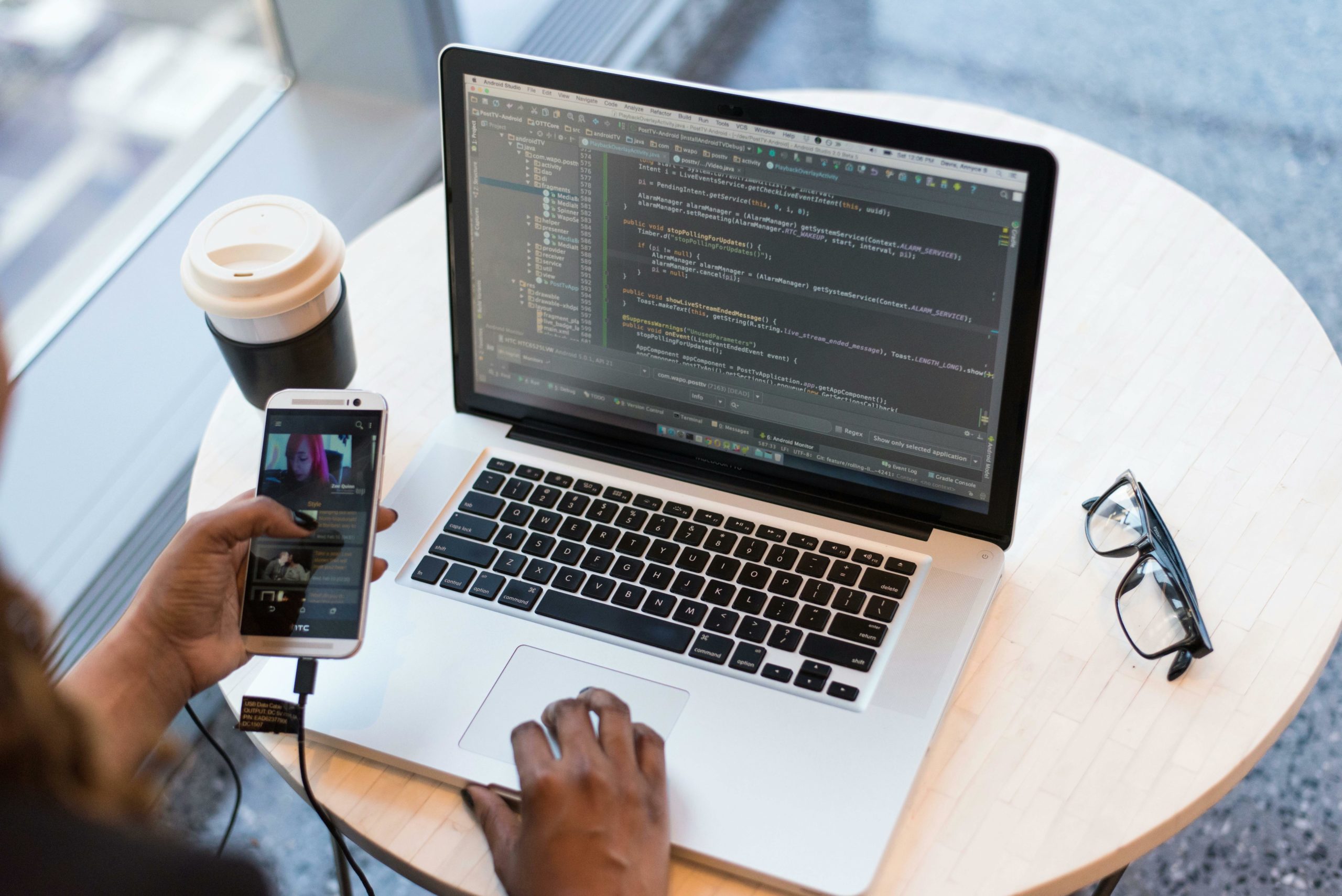 Person using phone and computer