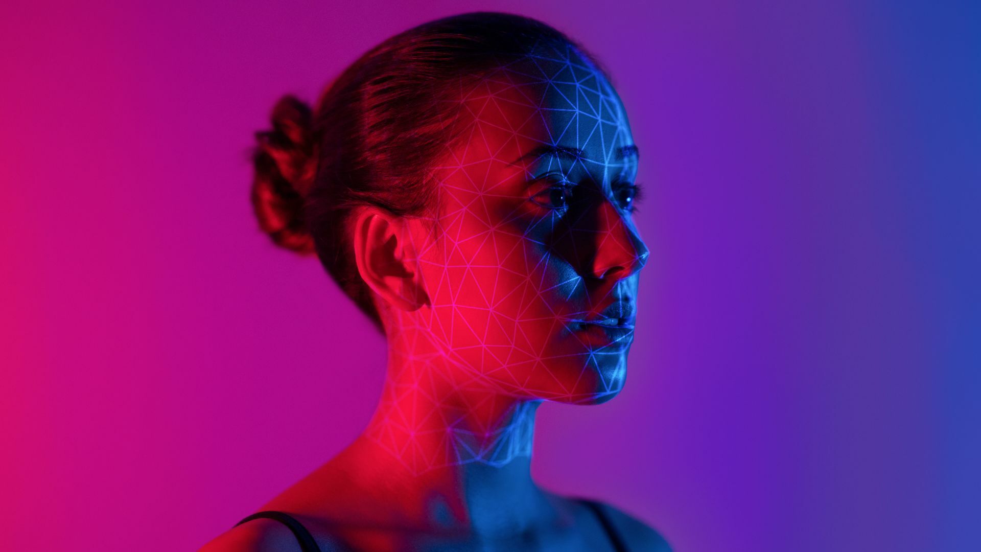 Young female human face with 3D mesh.