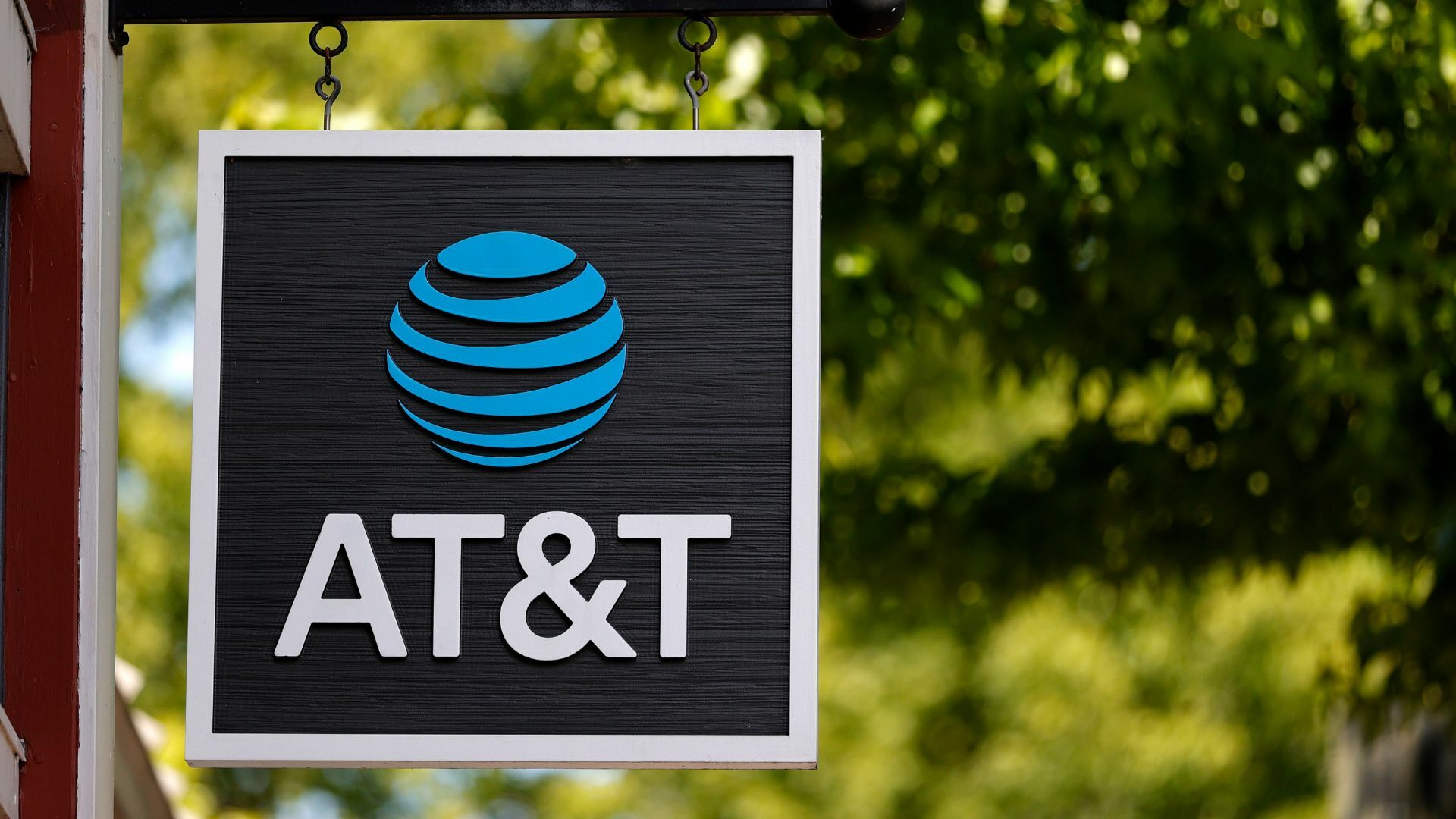 A sign is posted in front of an AT&T retail store.