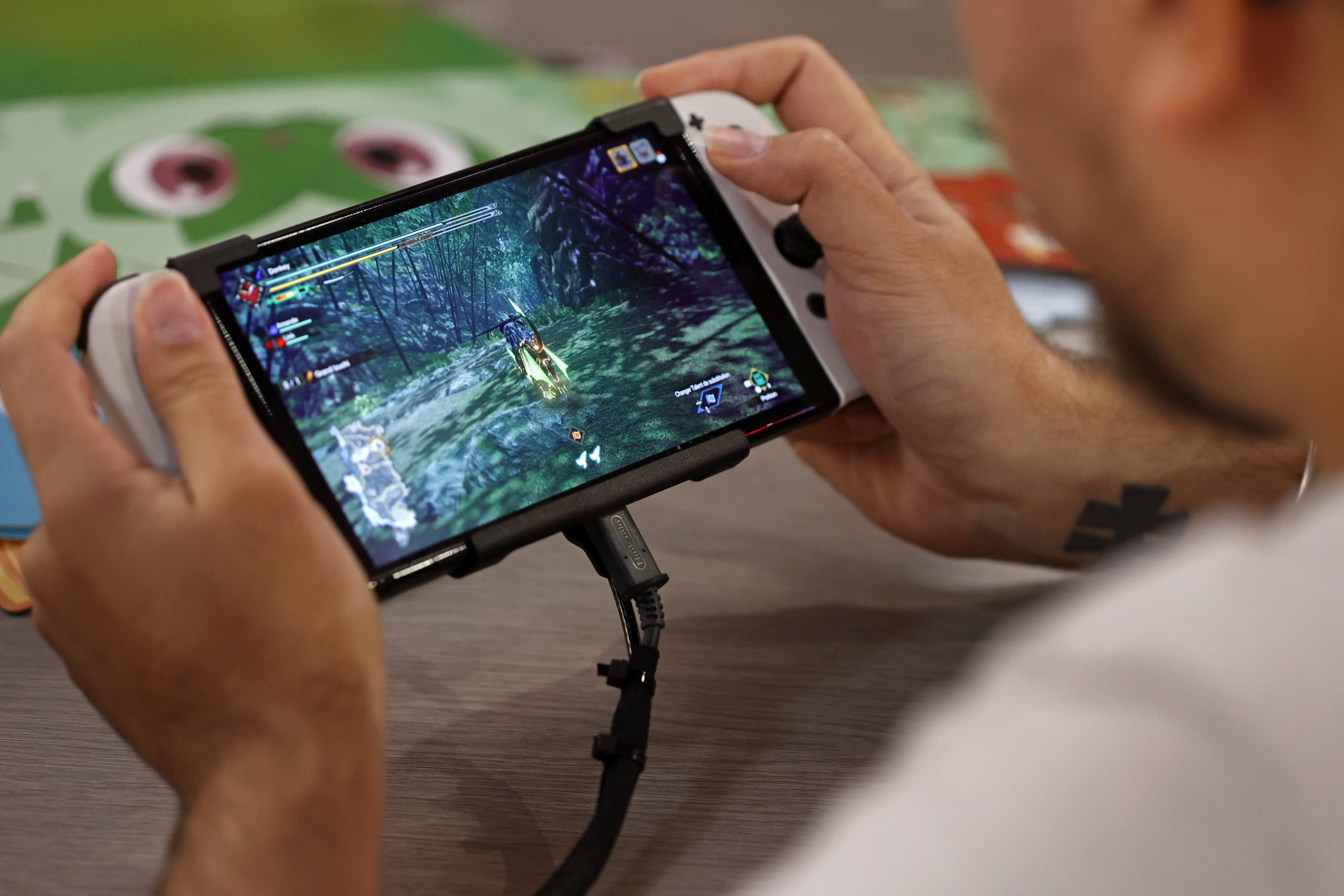 A gamer plays a video game on a Nintendo Switch console, OLED model during Paris Games Week 2022 at Parc des Expositions Porte de Versailles on November 03, 2022 in Paris, France.